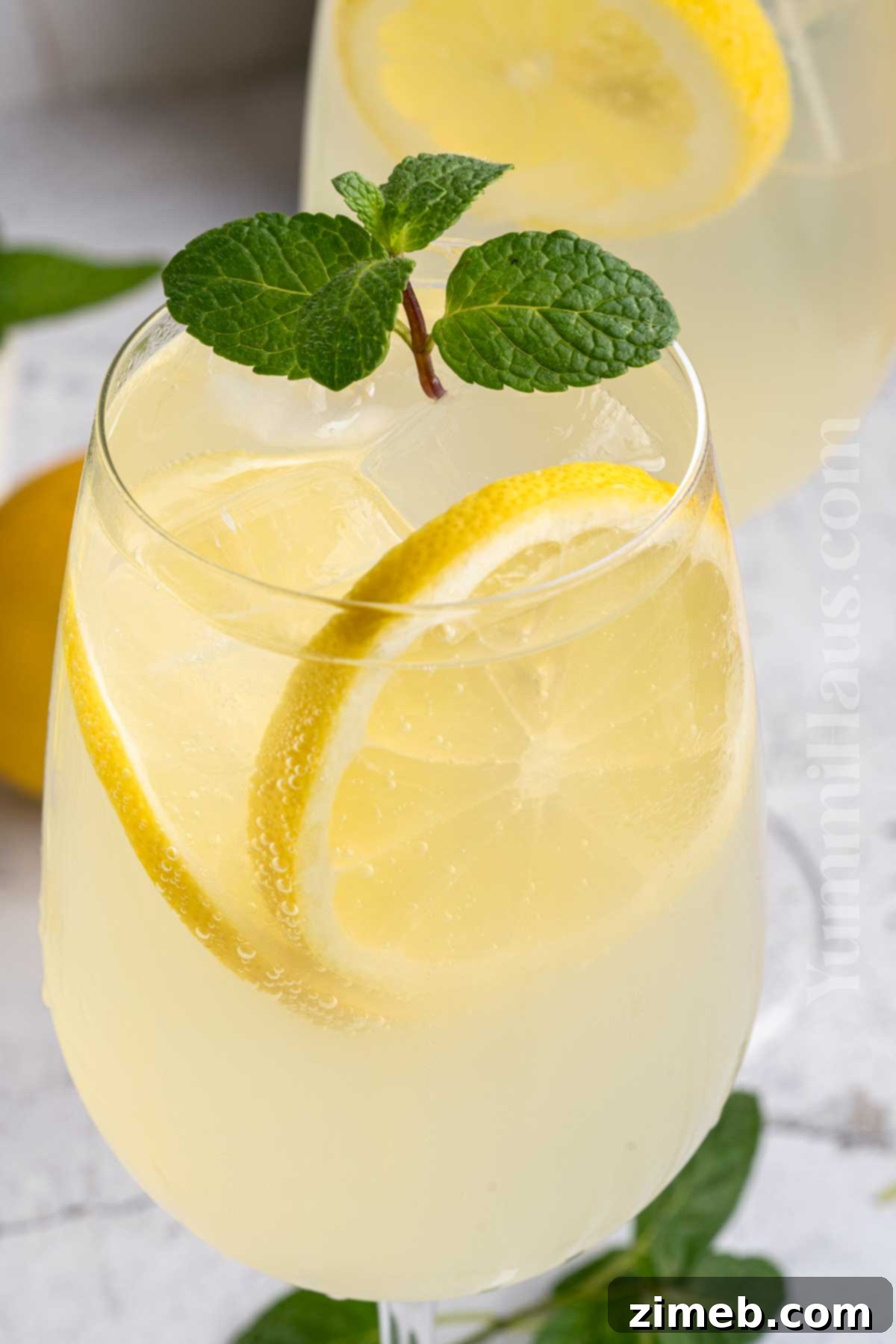 Refreshing Limoncello Spritz 2 A refreshing Limoncello Spritz cocktail garnished with lemon slices and mint, perfect for summer