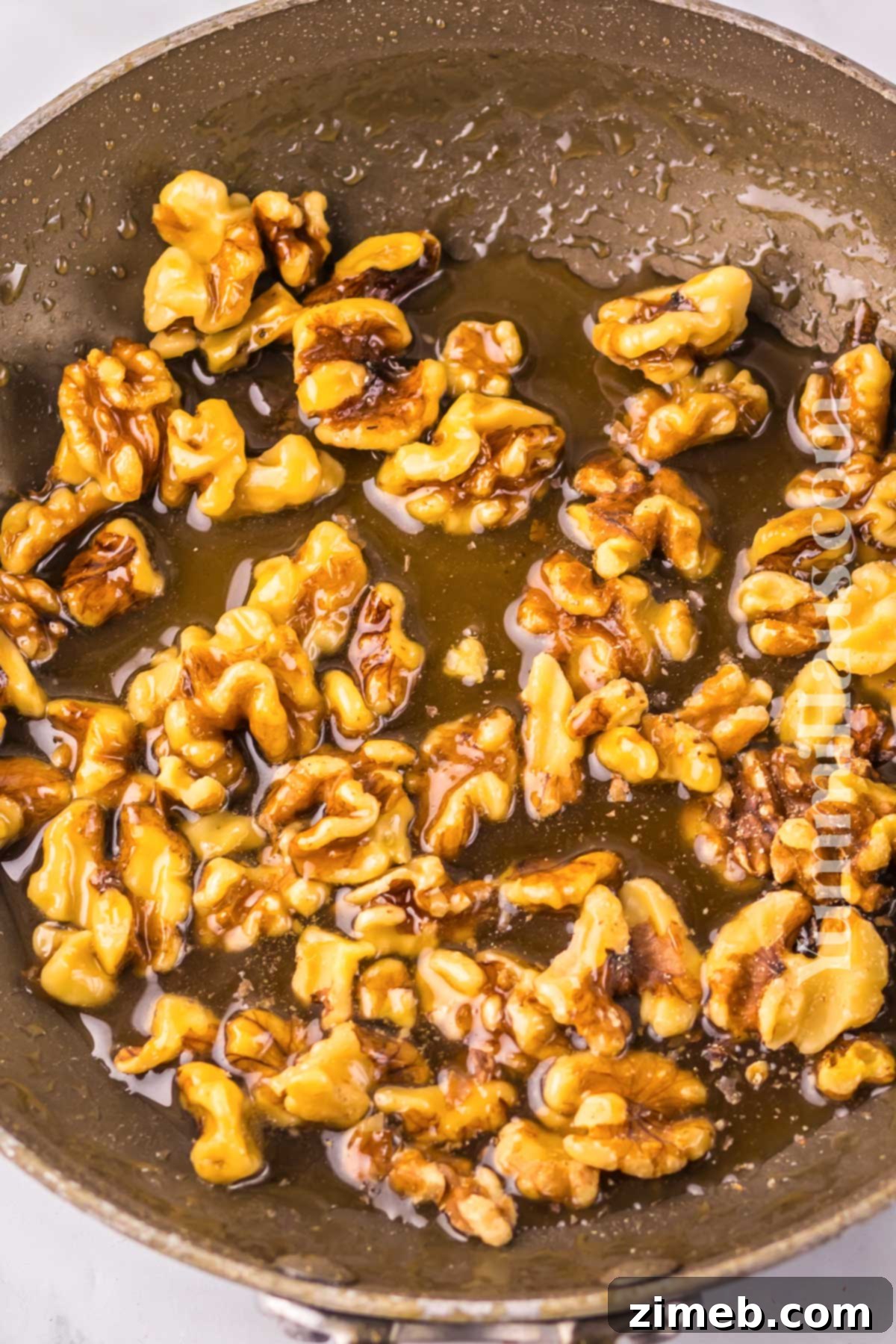 Golden Honey Walnut Shrimp 5 Sautéing walnuts for candied topping in Honey Walnut Shrimp recipe.