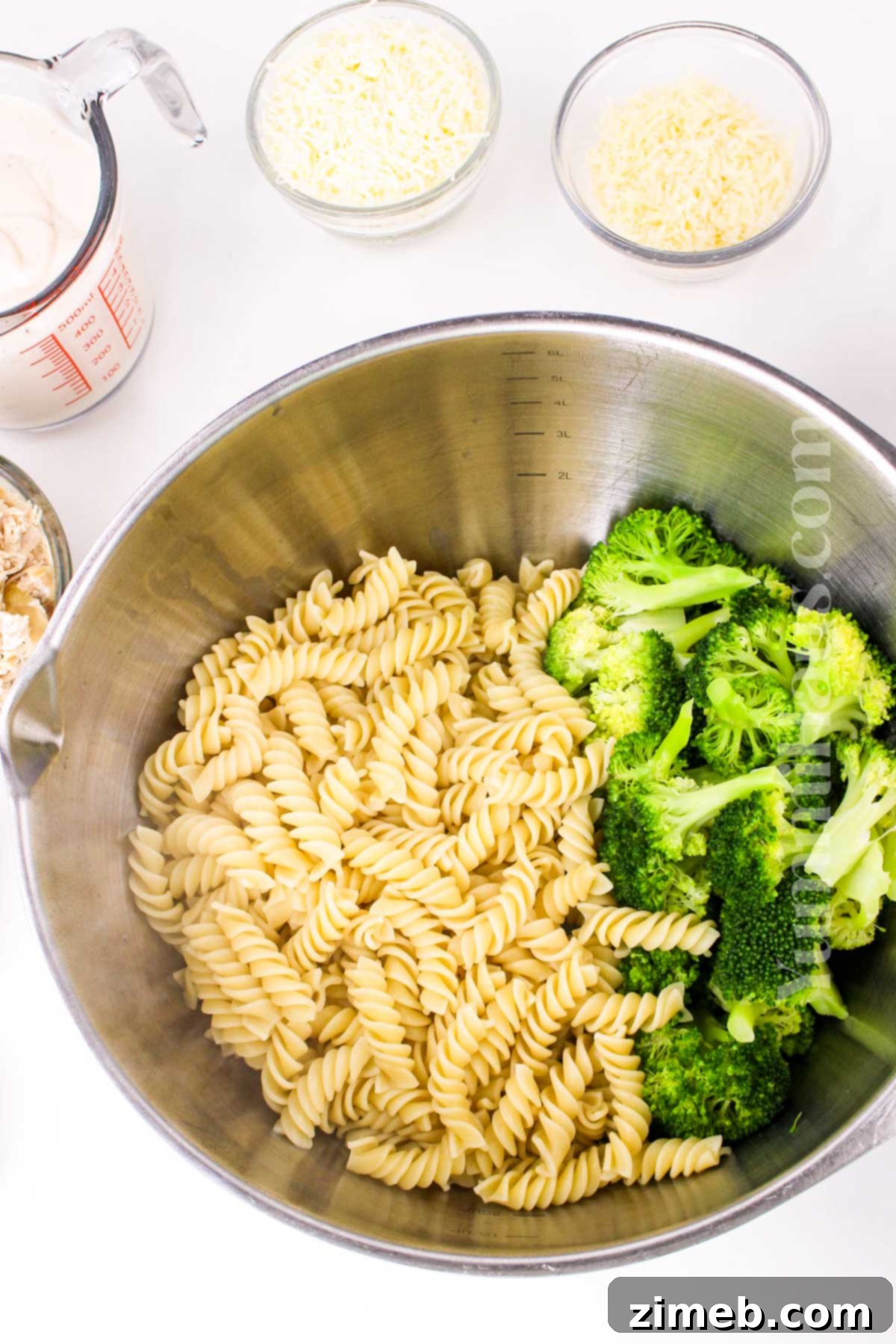 Creamy Chicken and Broccoli Alfredo Bake 5 Mixing the ingredients for Chicken Broccoli Alfredo Casserole