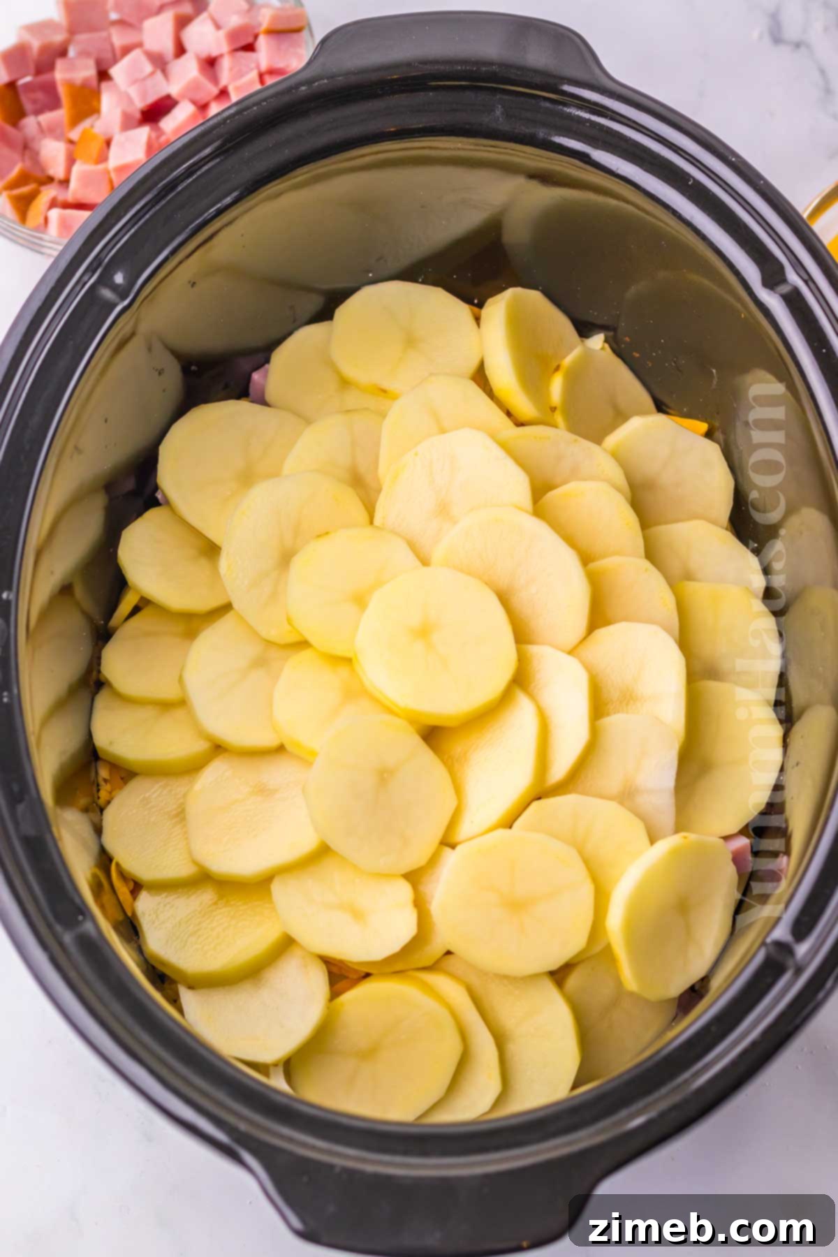 Slow Cooker Scalloped Ham and Potatoes 6 Layering ingredients for creamy Slow Cooker Scalloped Ham and Potatoes