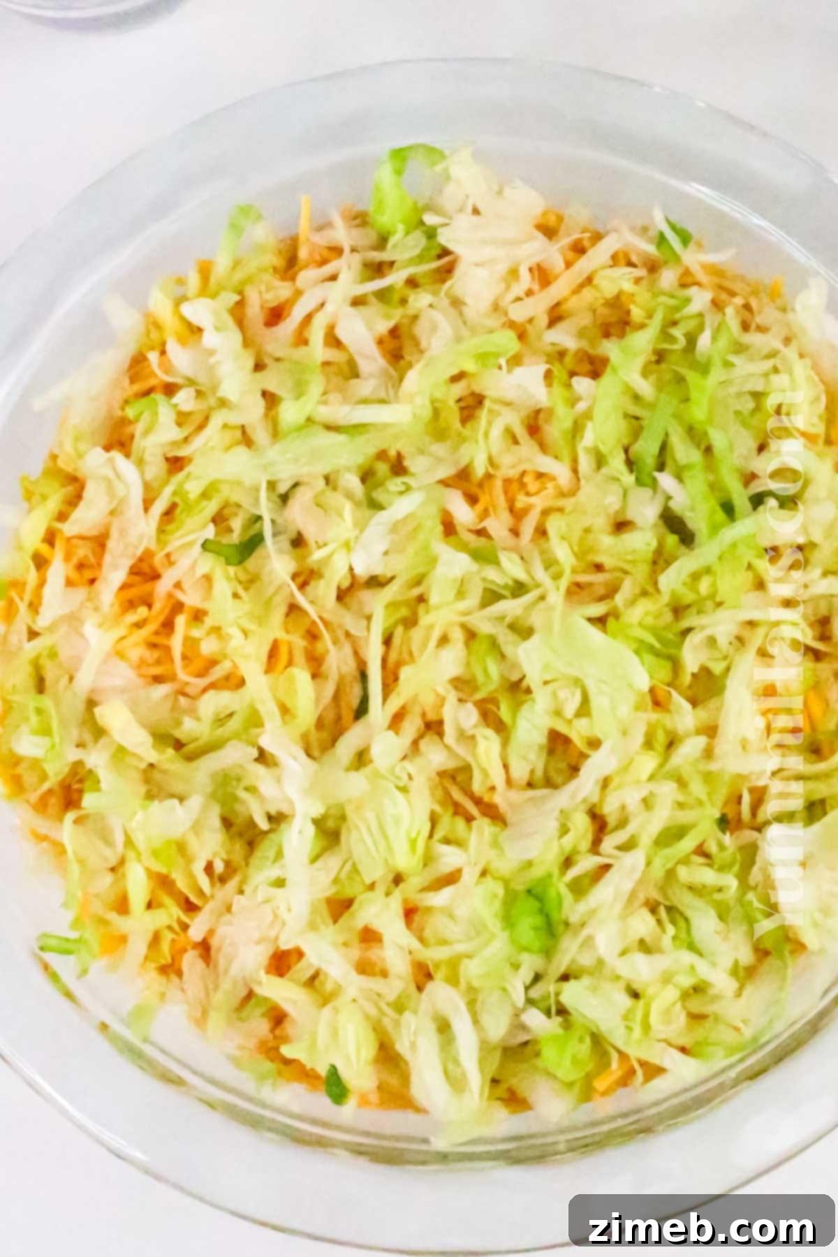 Fiesta Taco Dip 7 Assembling the layers of a vibrant taco dip