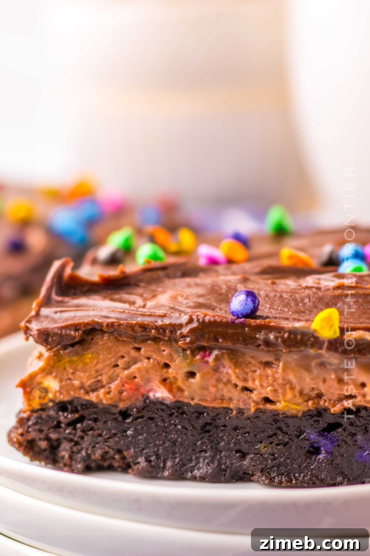 Cosmic Brownie Dream 2 Cosmic Brownie Lush, a layered dessert with fudgy brownie, creamy chocolate pudding, whipped topping, and rainbow chips