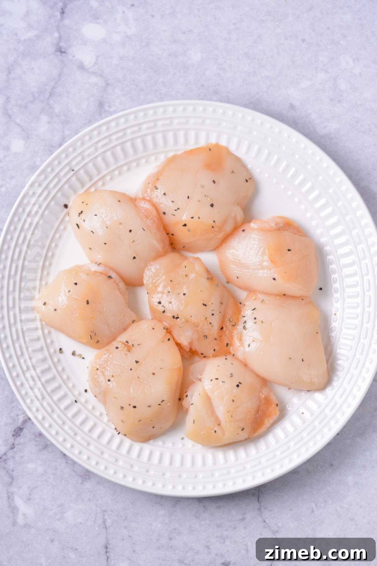 Seasoning scallops before searing