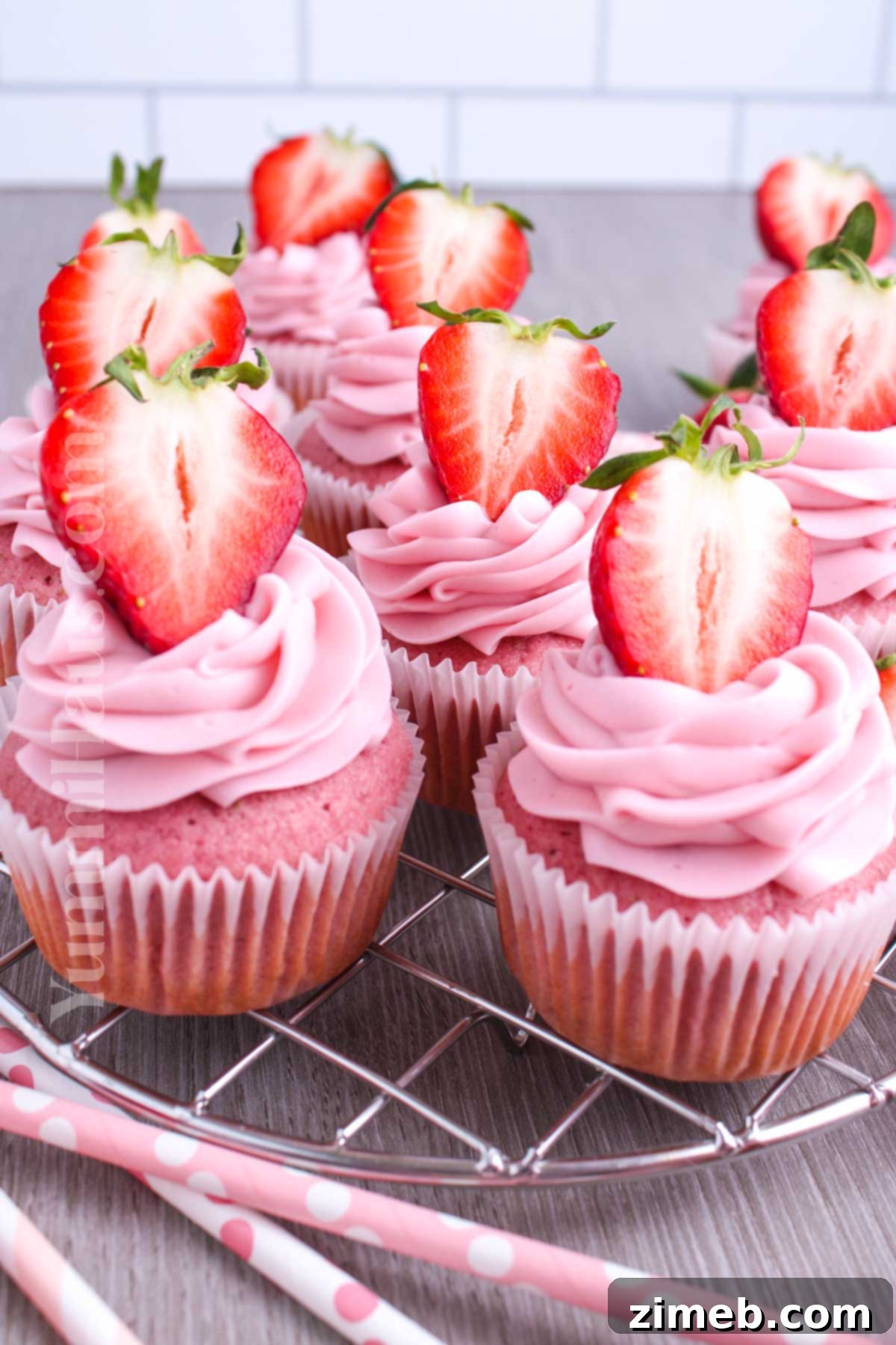 Sweet Strawberry Delights 14 Display of homemade Strawberry Cupcakes with pink frosting and fresh berries