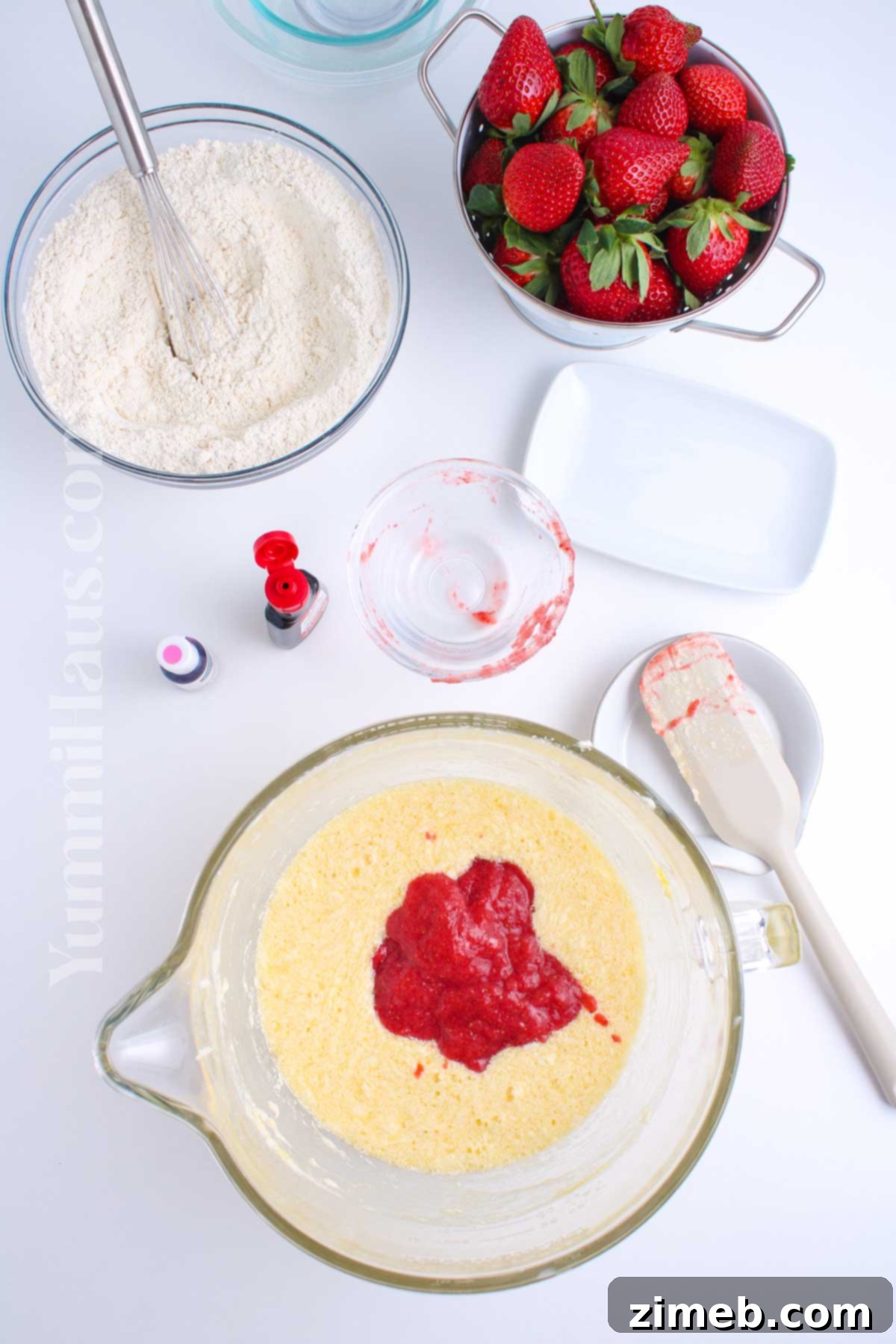 Sweet Strawberry Delights 5 Adding strawberry puree to pink cake batter in a stand mixer