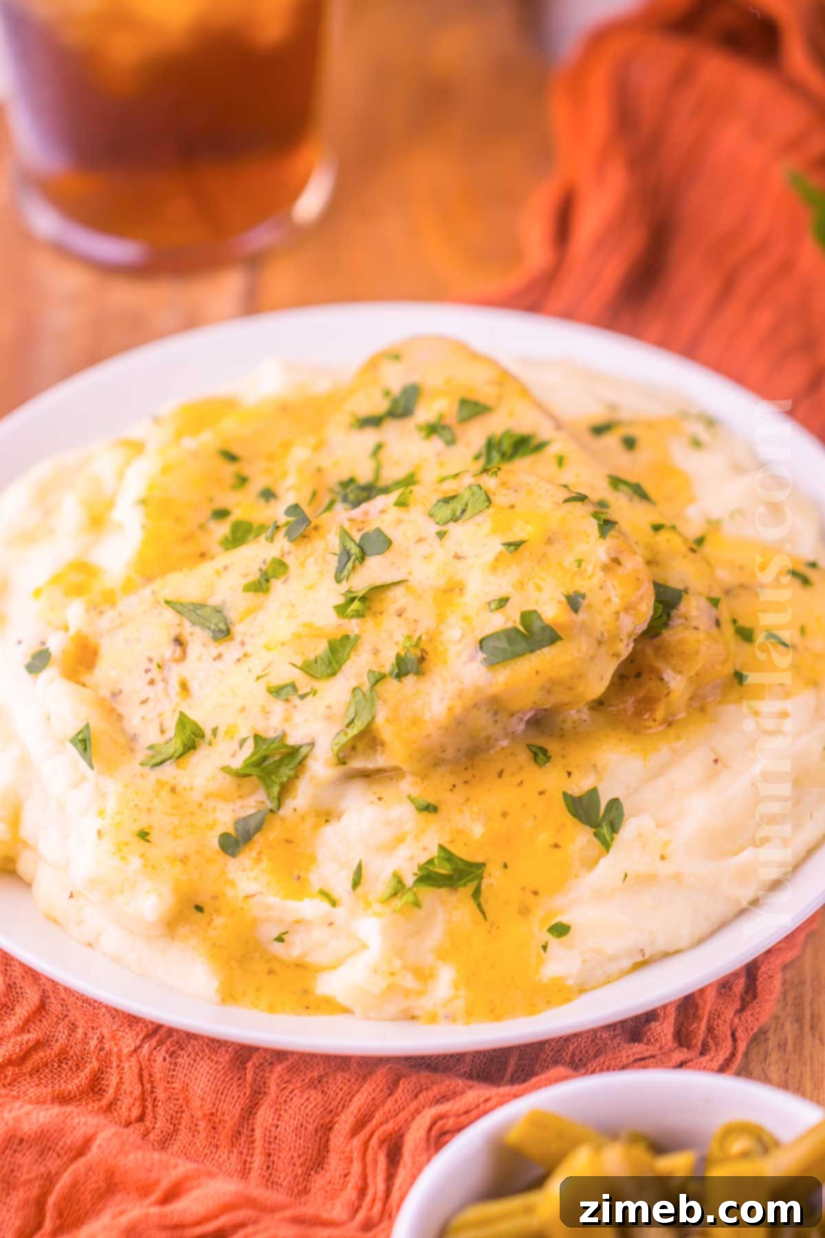 Crockpot pork chops with creamy ranch gravy, a perfect comforting meal.