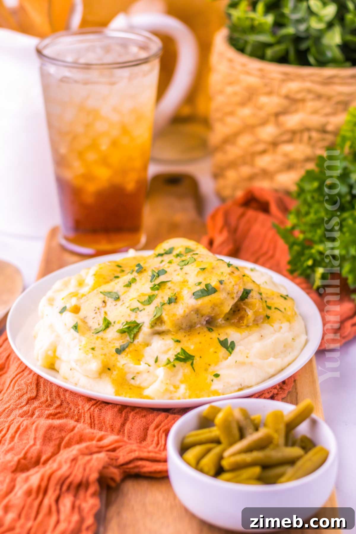 Easy pork dinner in the crockpot, showing tender pork chops with creamy ranch gravy.