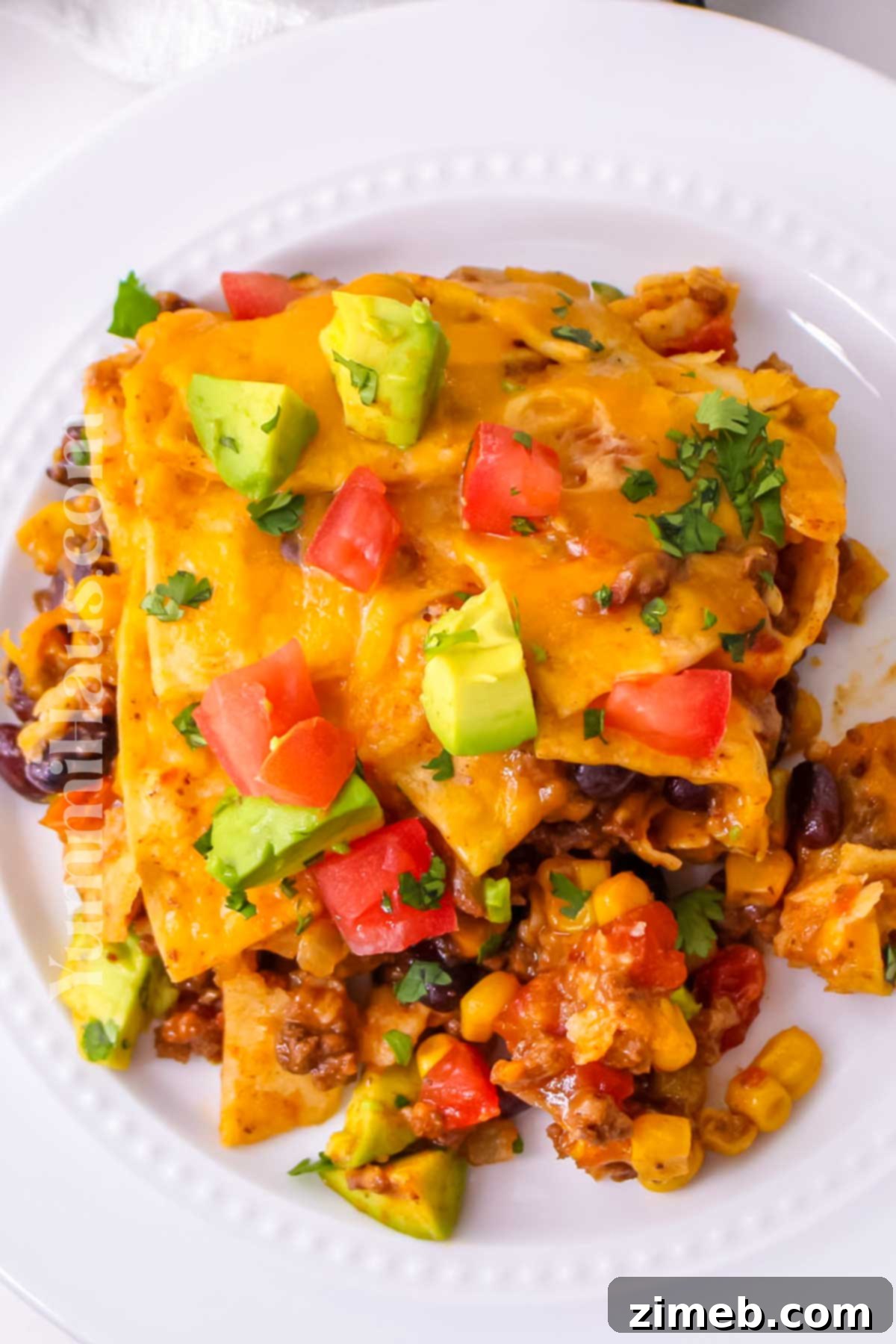 Easy Slow Cooker Mexican Casserole 15 Full shot of a slow cooker with Mexican casserole, garnished and ready to serve.