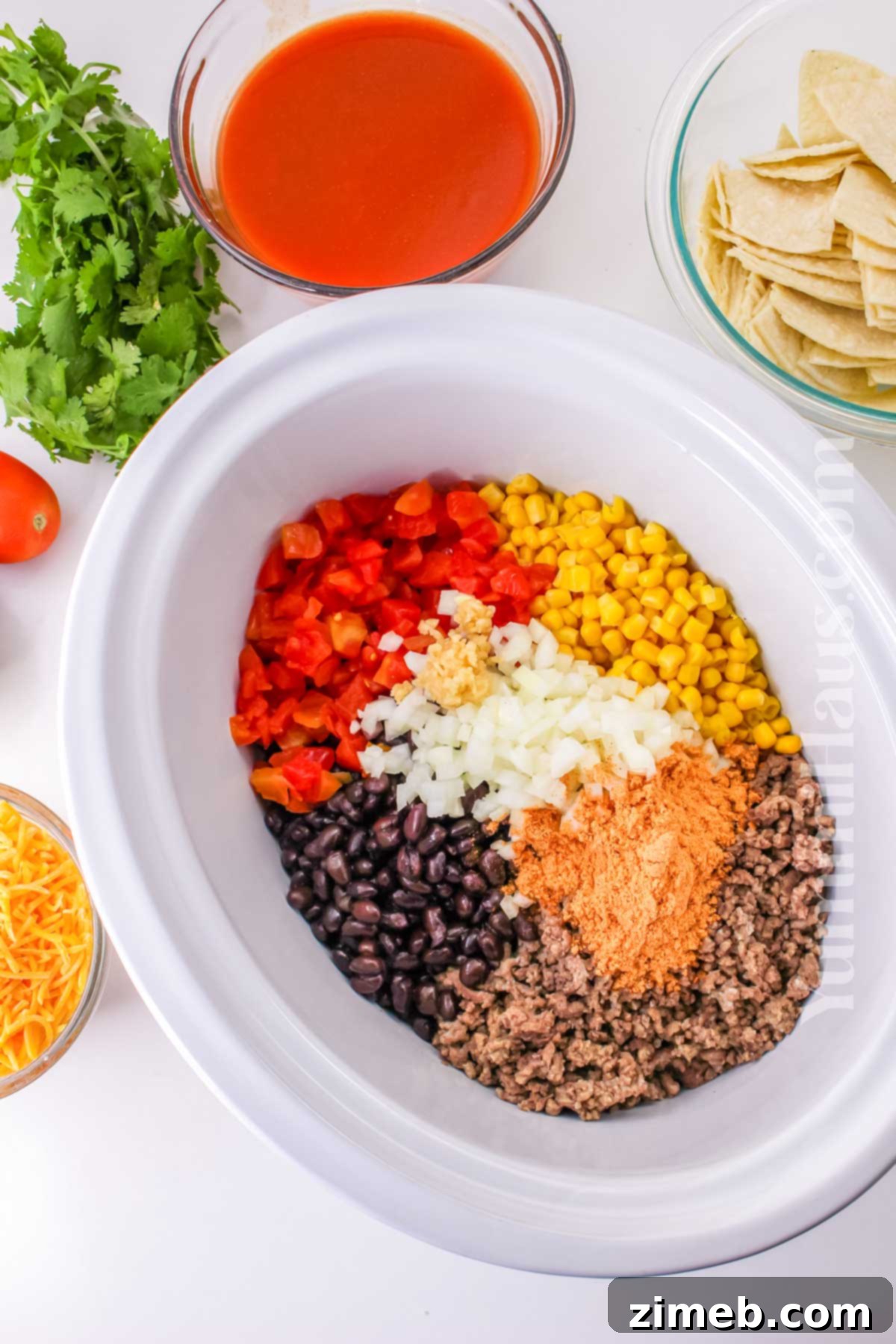 Easy Slow Cooker Mexican Casserole 5 Crockpot Mexican Casserole being scooped out, showing layers of beef, cheese, and tortillas.