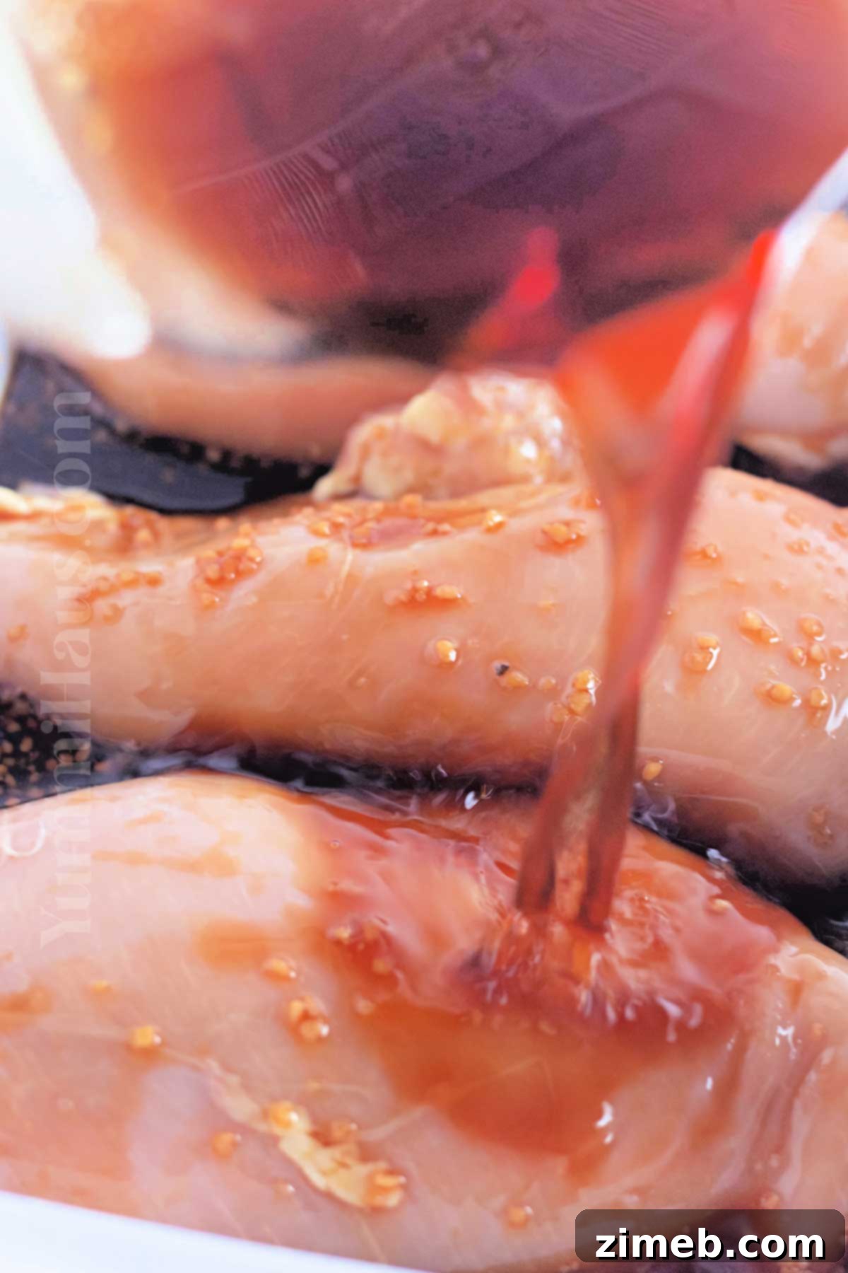Caramelized Honey Garlic Chicken 5 Pouring the sweet and savory honey garlic sauce over raw chicken breasts in a slow cooker, ready for cooking.