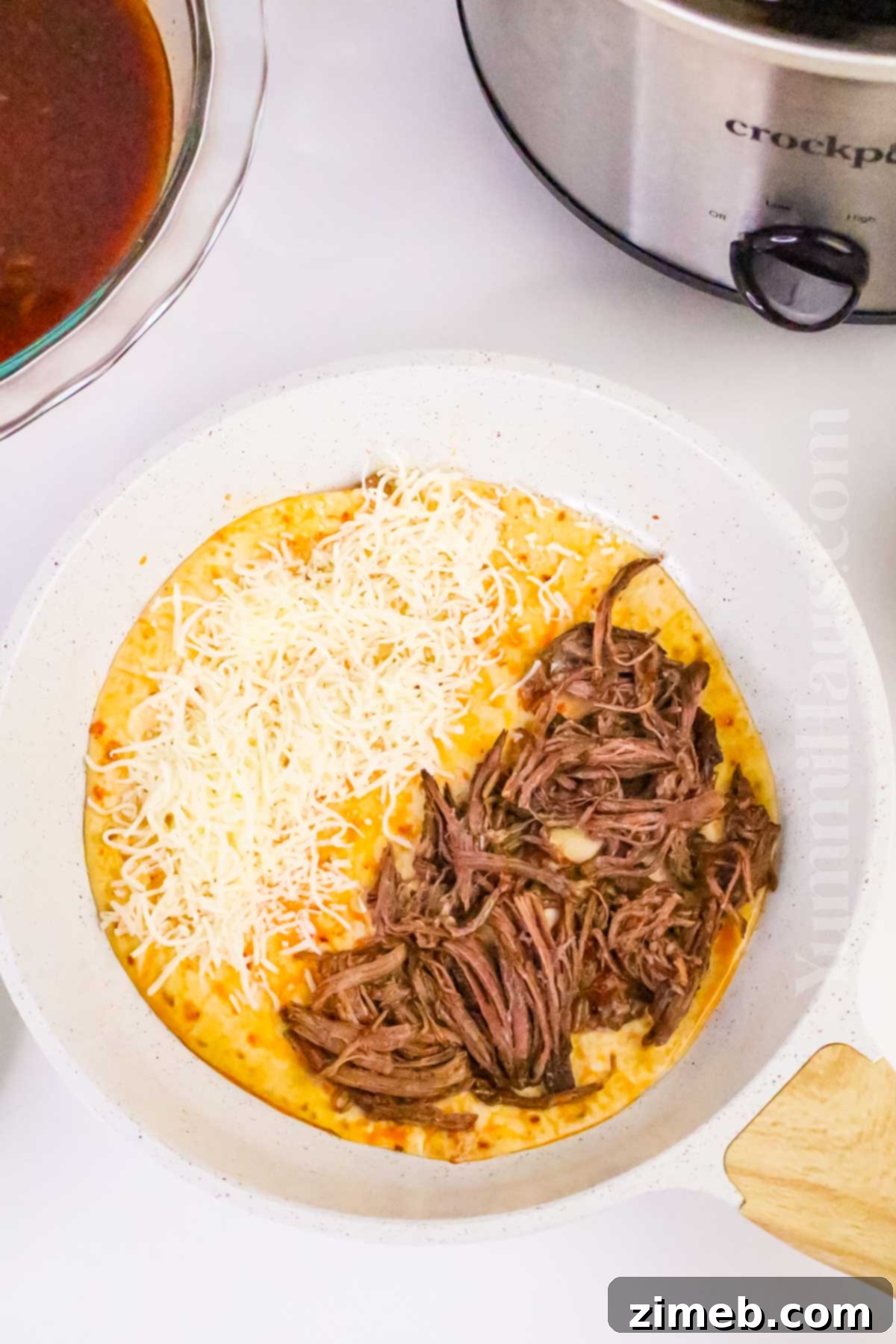 Easy Slow Cooker Birria Tacos 9 frying in the skillet