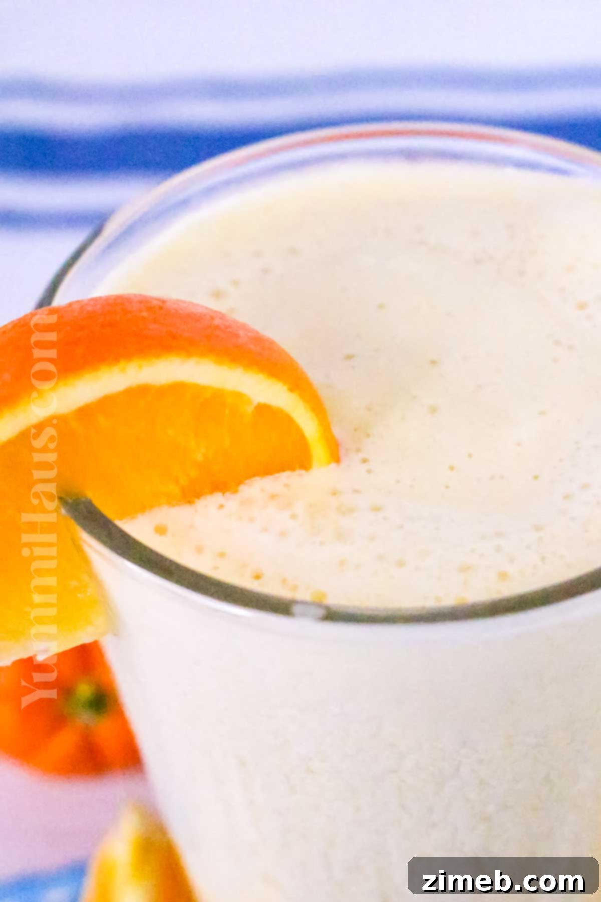 Copycat orange drink served in a tall glass with an orange slice