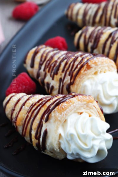 Delicate Cream Horns with flaky puff pastry shells, filled with a rich, sweet cream cheese and whipped cream mixture.