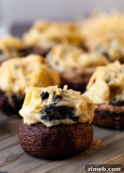 Savory Spinach Artichoke Stuffed Mushrooms, baked to golden perfection with a creamy cheese filling.