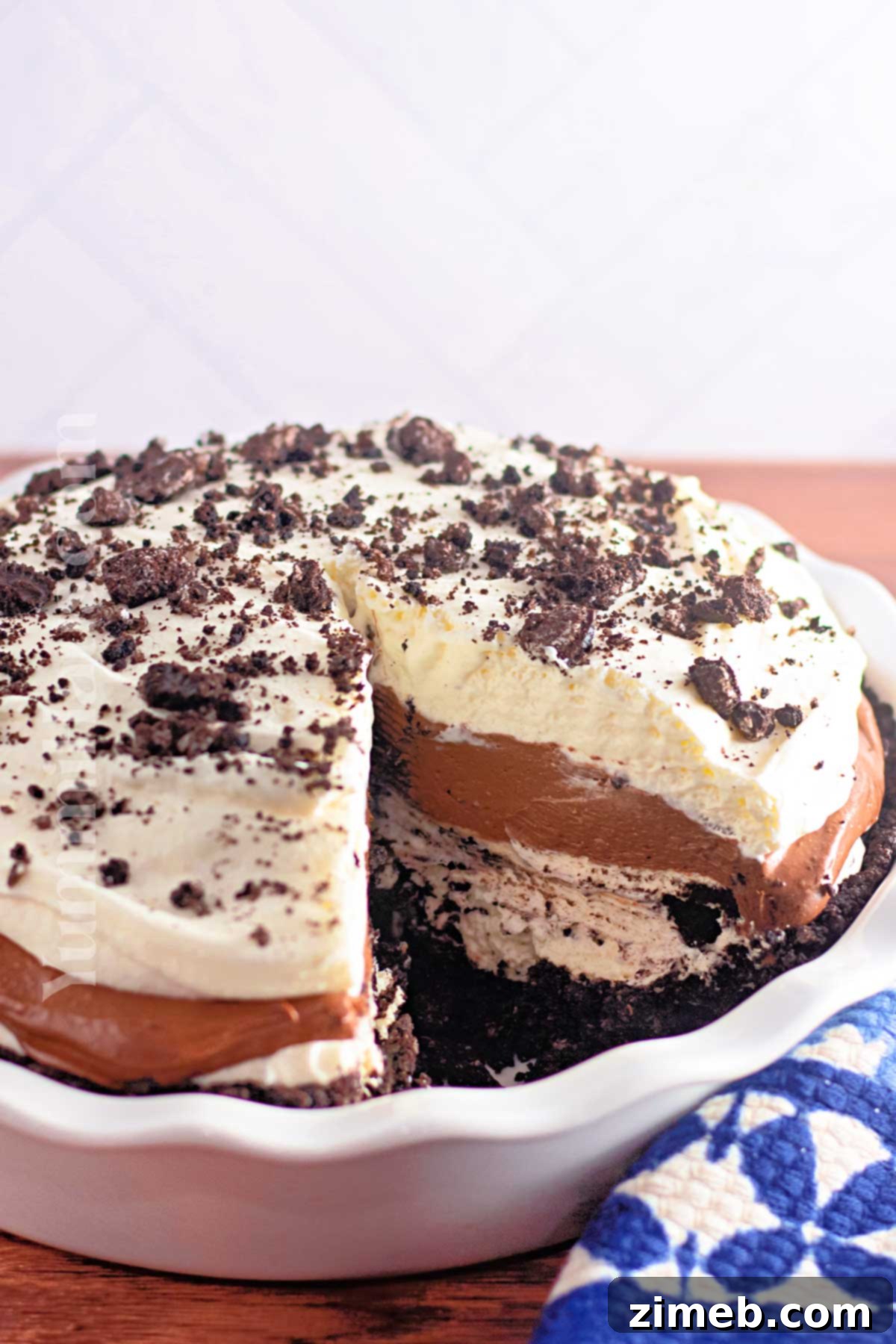 A slice of No-Bake Oreo Pie on a white plate