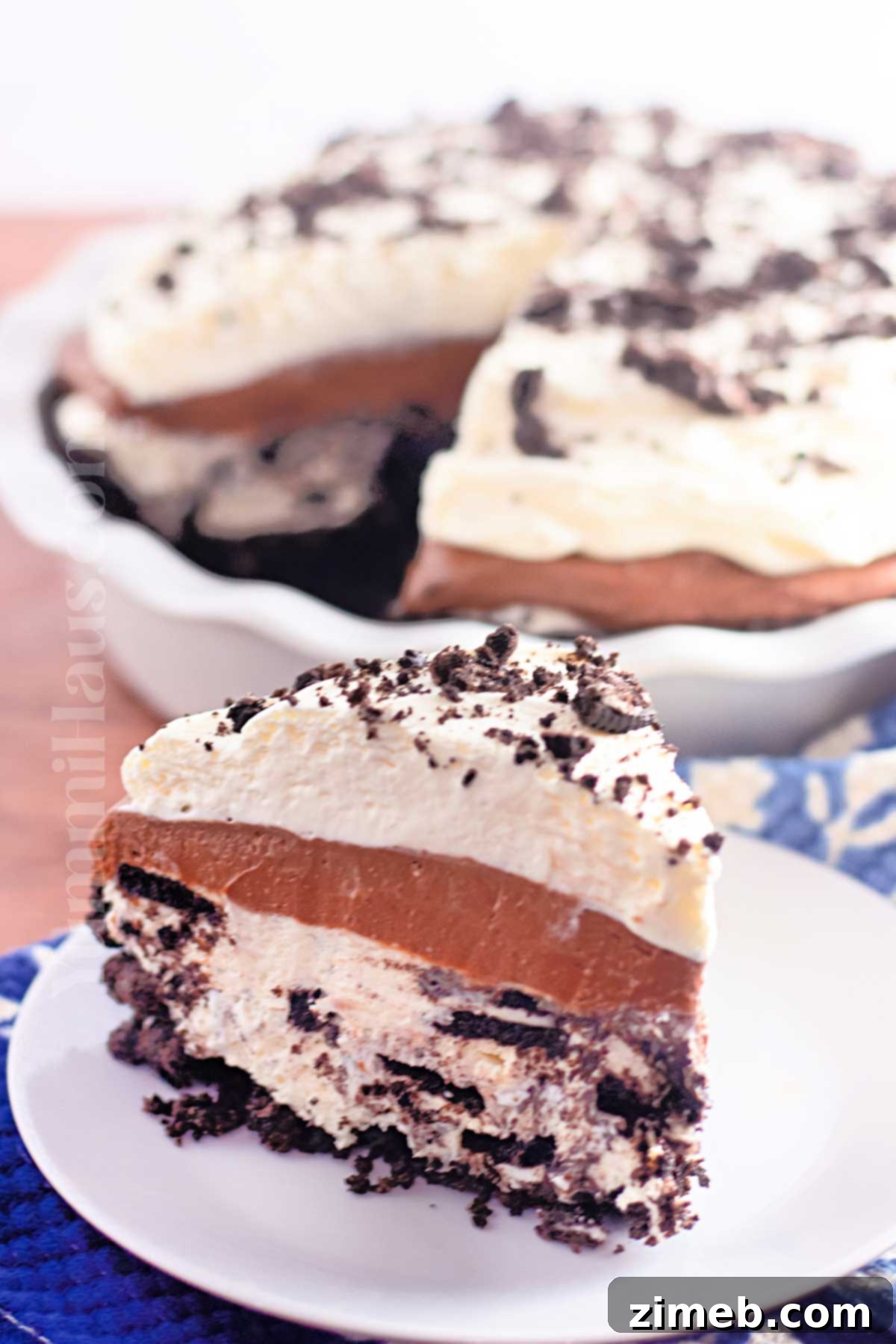 A perfectly sliced no-bake pie, showing its delicious cookie crust and creamy fillings
