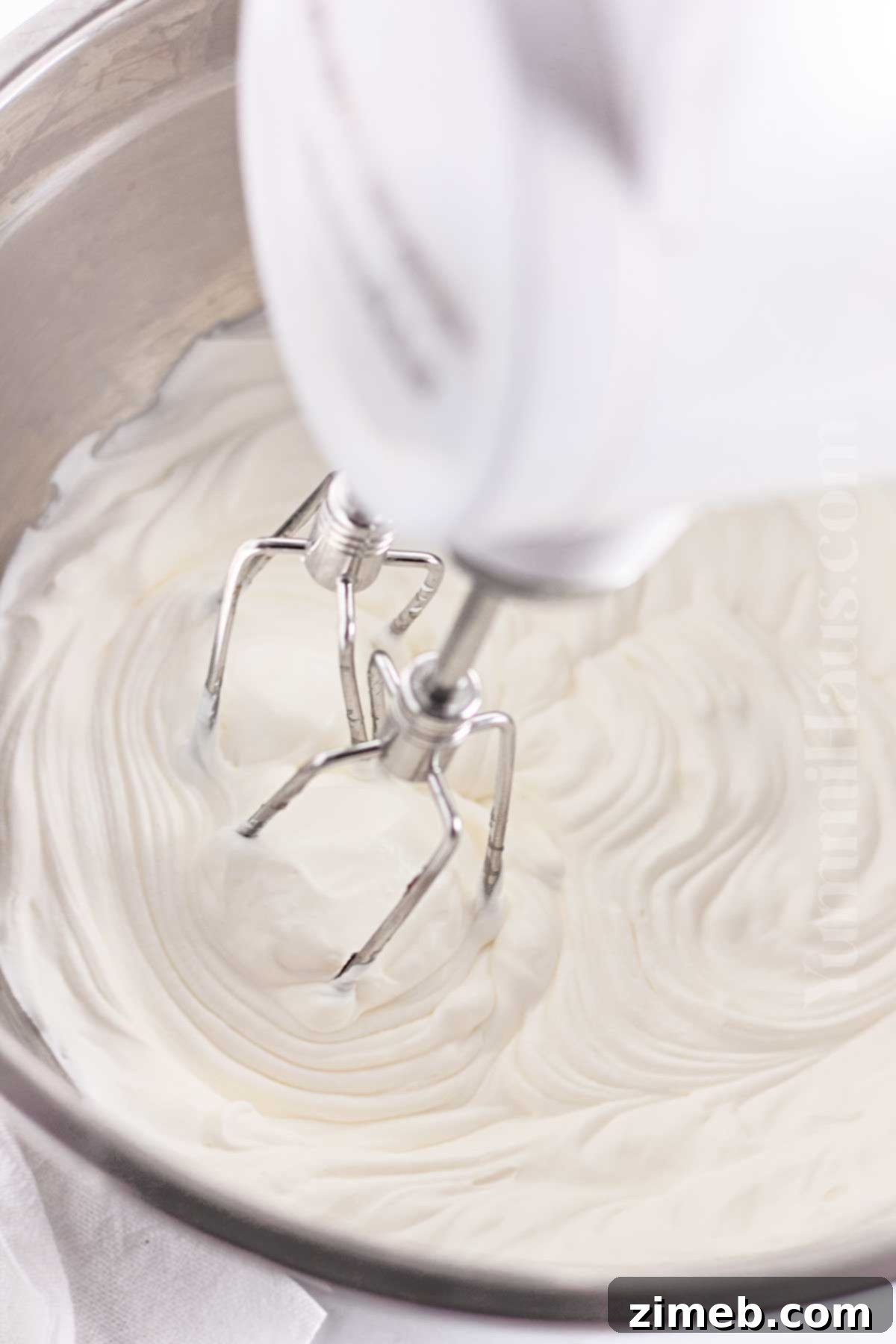Close-up of whipped cream being prepared for the Oreo pie topping