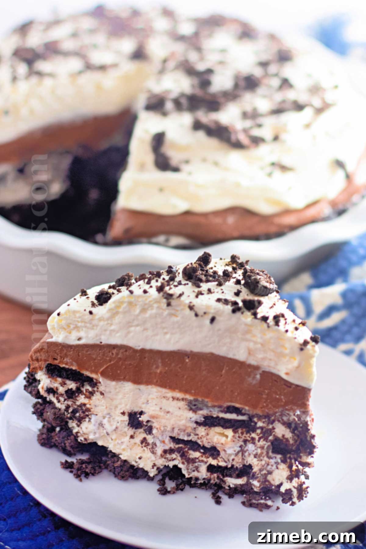 A whole No-Bake Oreo Pie decorated with whipped cream and Oreo crumbles