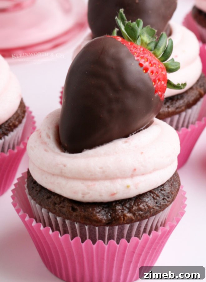 Celebrate with Cupcakes: Endless Flavors for Every Occasion 20 Chocolate cupcakes topped with strawberry frosting and fresh chocolate-dipped strawberries, ideal for Valentine's or Mother's Day.