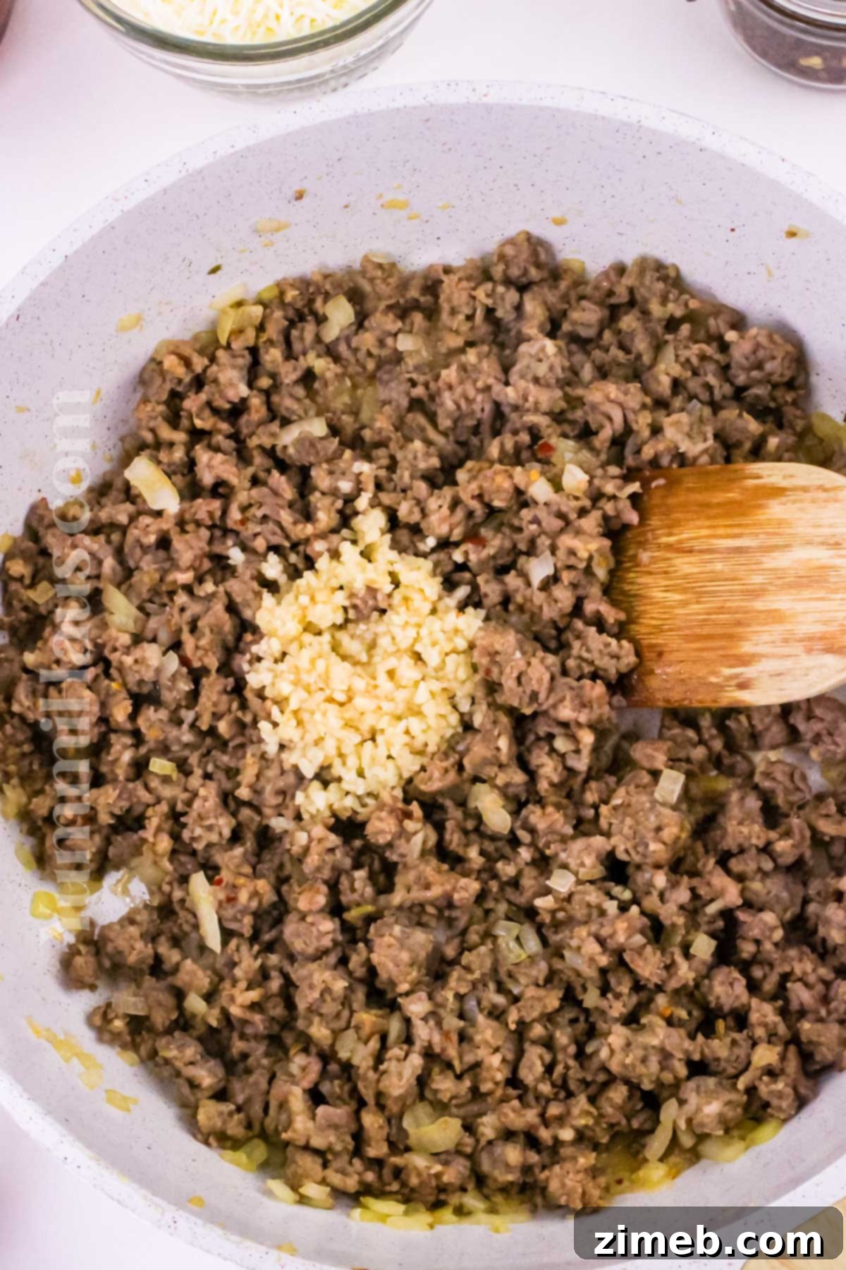 Step-by-step image of browning Italian sausage in a skillet
