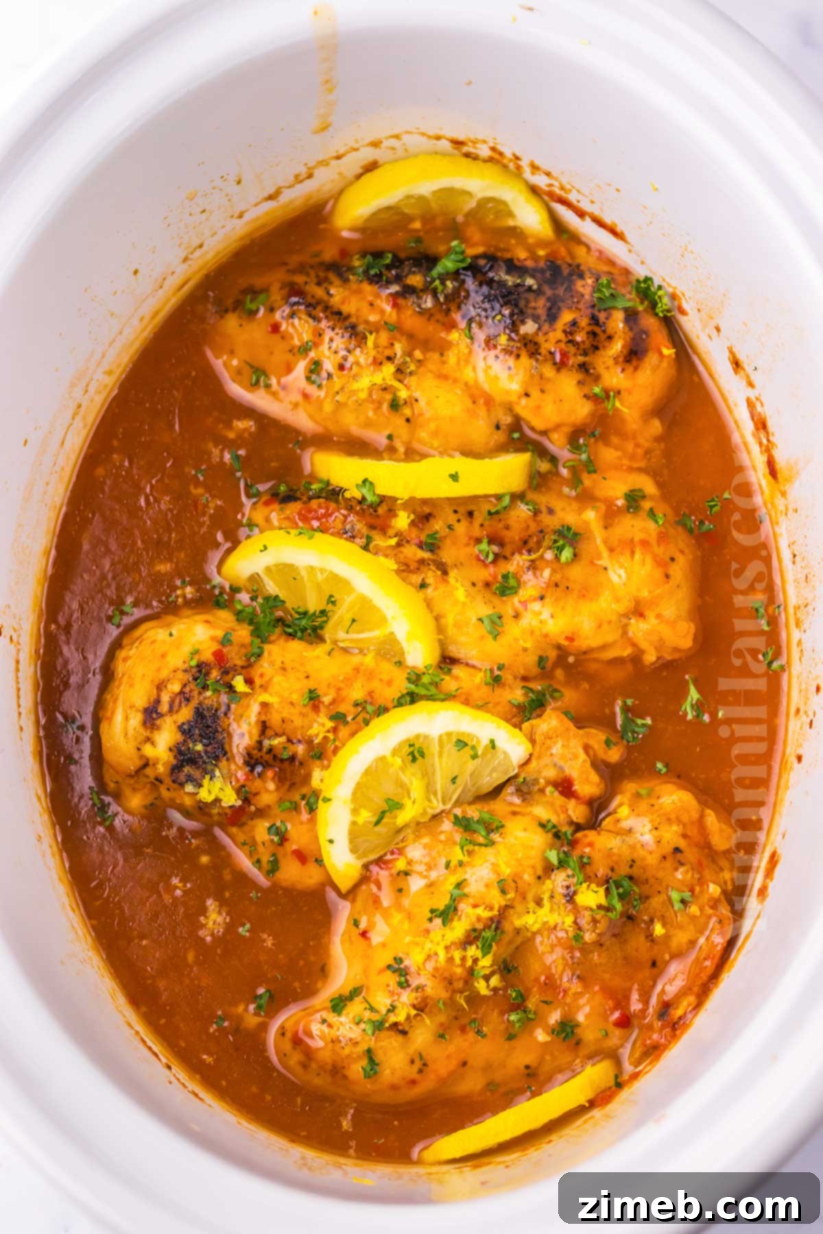 Sweet and Tart Slow Cooker Chicken 7 Cooked lemon chicken simmering in the crockpot, ready to be served.