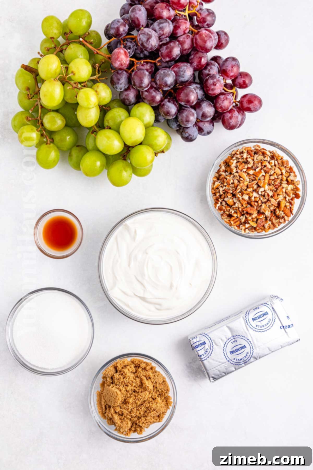 Creamy Grape Salad Delight 3 Fresh Ingredients for Grape Salad including red and green grapes, cream cheese, Greek yogurt, vanilla, sugars, and pecans.
