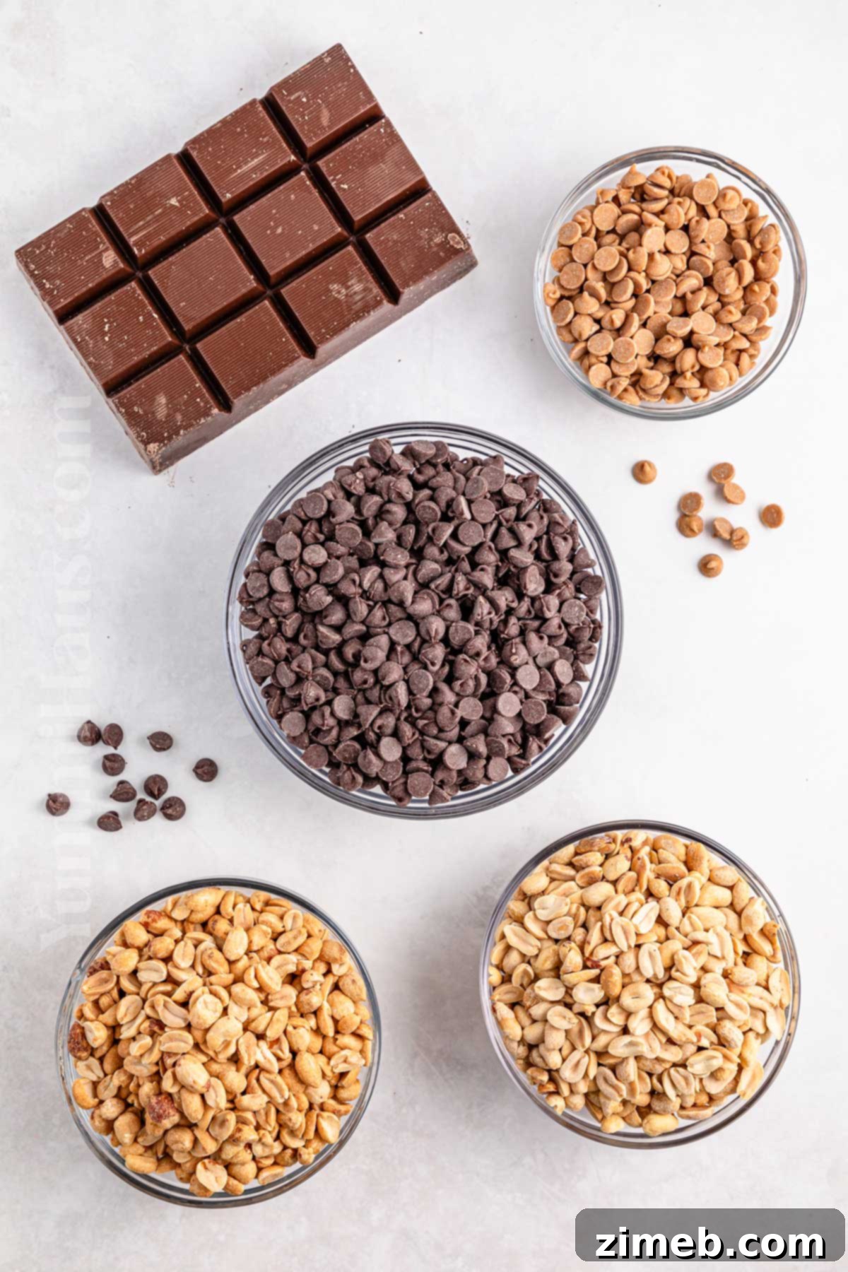 Ingredients for Crockpot Candy laid out: peanuts, chocolate chips, almond bark, and peanut butter chips.