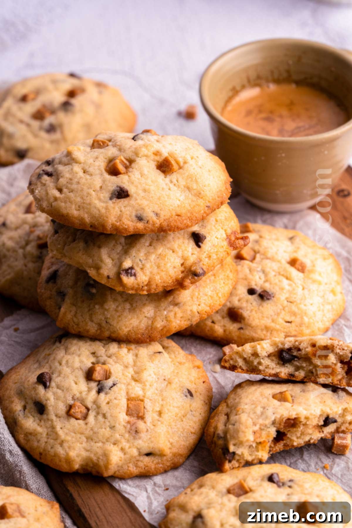 Stack of freshly baked caramel cookies with visible caramel bits and chocolate chips.