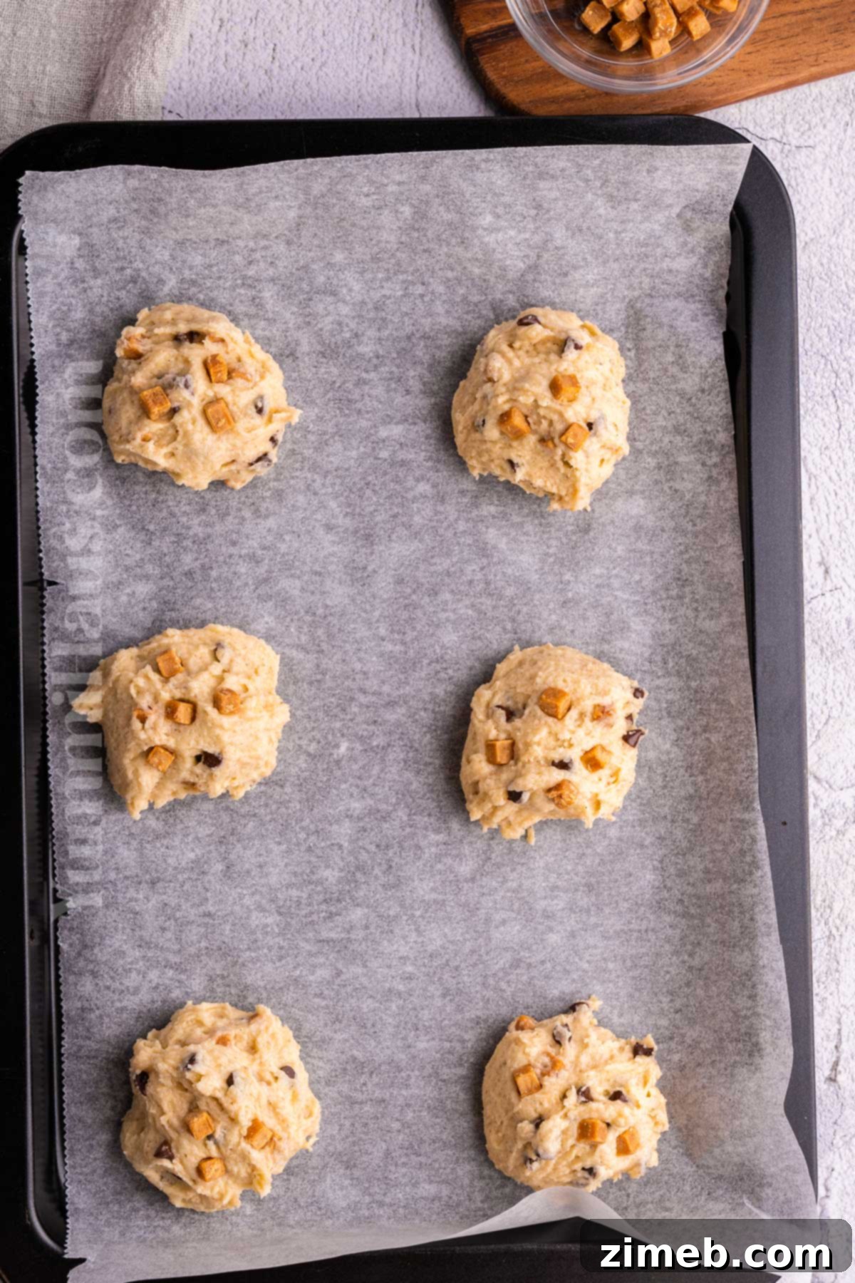 Cookie dough balls ready to be baked into delicious caramel cookies.