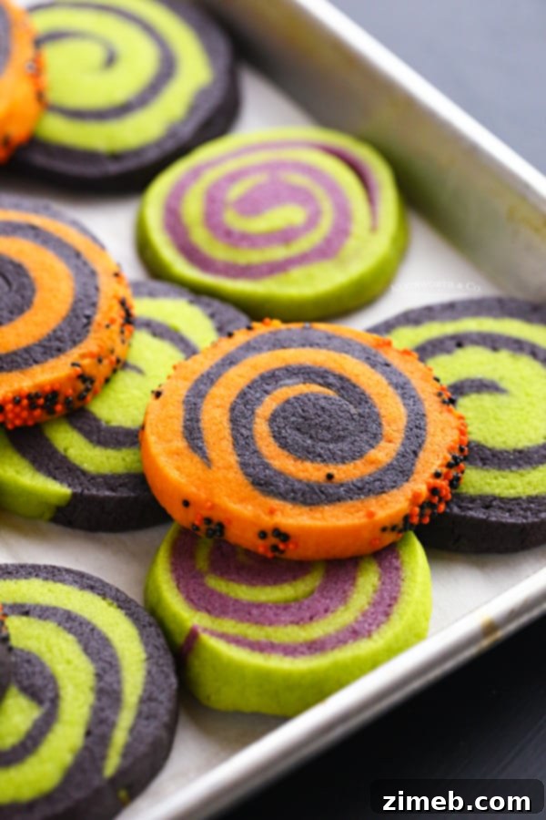 11 Ghoulish Halloween Cookie and Dough Creations 8 Soft pinwheel Halloween sugar cookies with orange and black swirls and sprinkles.
