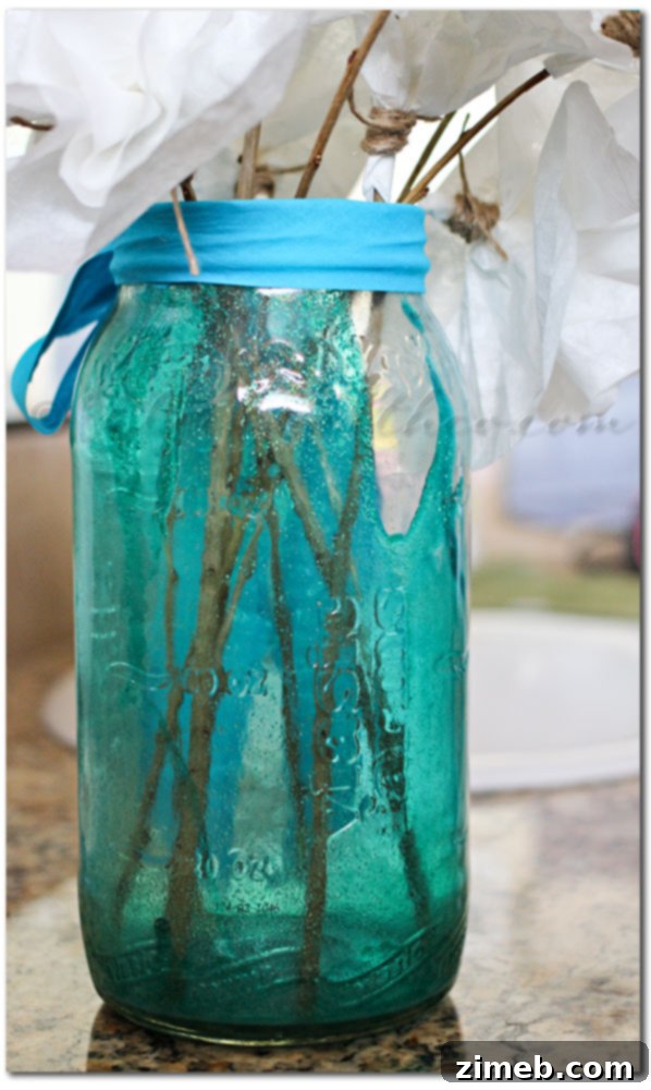 From Coffee Filters to Beautiful Blooms 4 Securing a coffee filter flower to a branch with twine