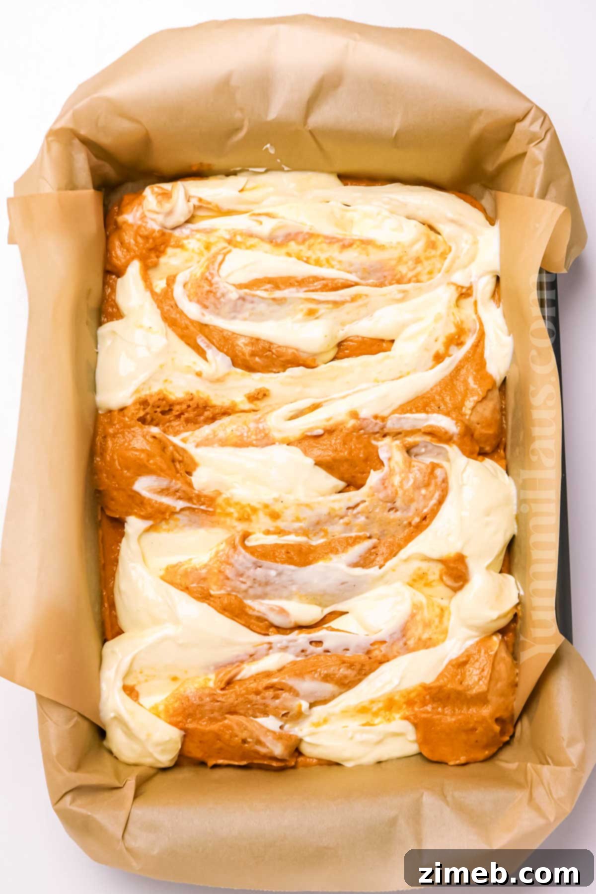 Swirling the cheesecake into the pumpkin cake batter