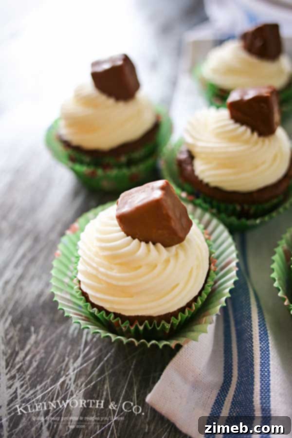 Looking for some game day food ideas? Game Day Snickers Cupcakes are an easy 3 - ingredient cupcake recipe loaded with Snickers candy bars, topped with a delicious & easy buttercream frosting & more Snickers minis. on kleinworthco.com