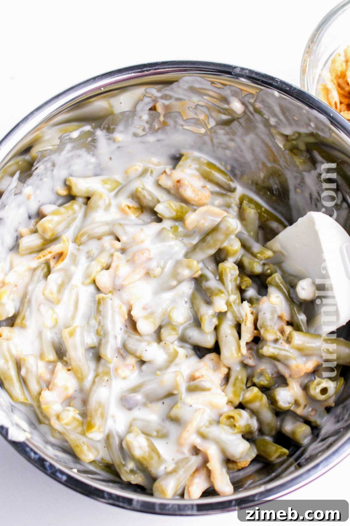 Mixing green beans for Green Bean Casserole.