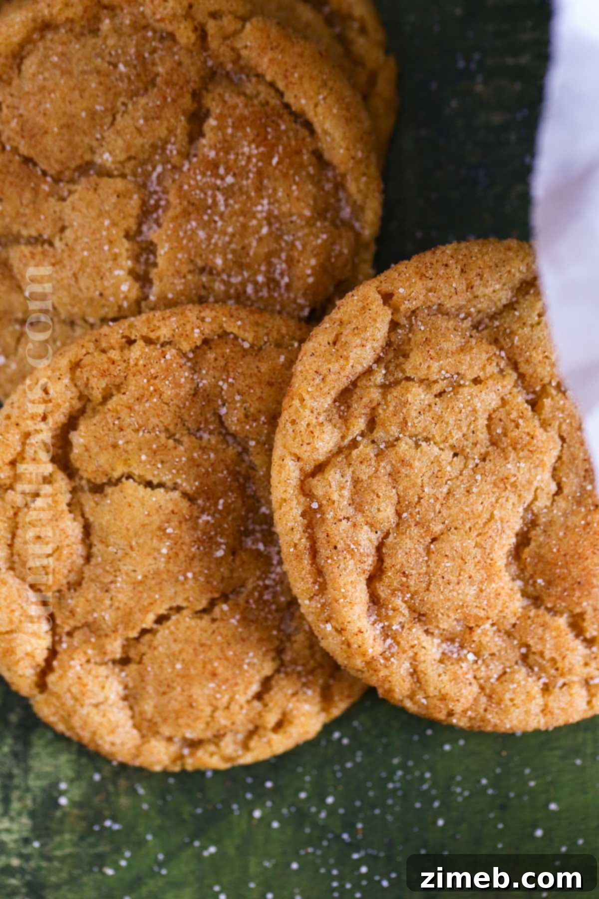 Chewy pumpkin cookies with cinnamon sugar topping on a wire rack