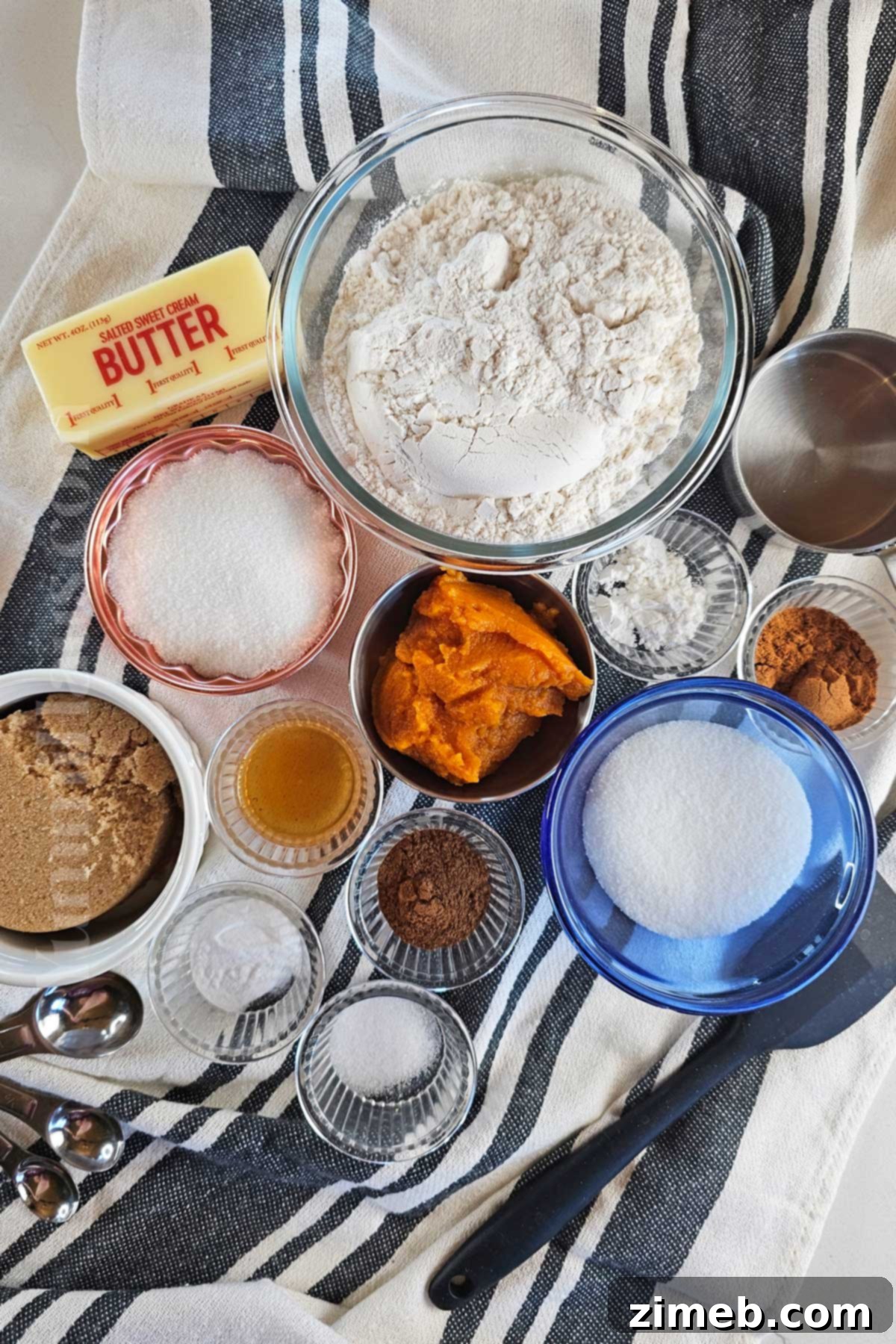 Ingredients for making Pumpkin Snickerdoodles on a wooden surface