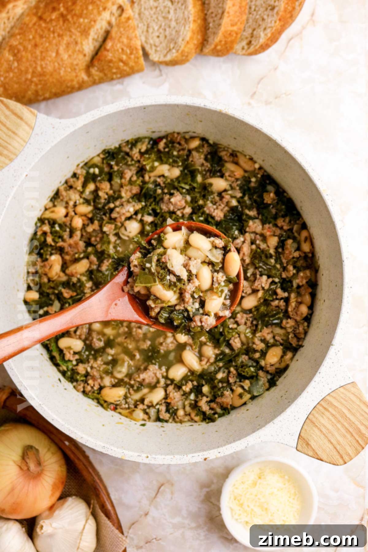 Tuscan Sausage, Kale, and White Bean Soup 15 A cozy scene with a pot of soup simmering on a stovetop, inviting warmth and comfort.