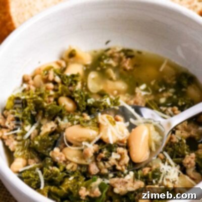 Delicious Cannellini Bean, Sausage, and Kale Soup in a bowl.