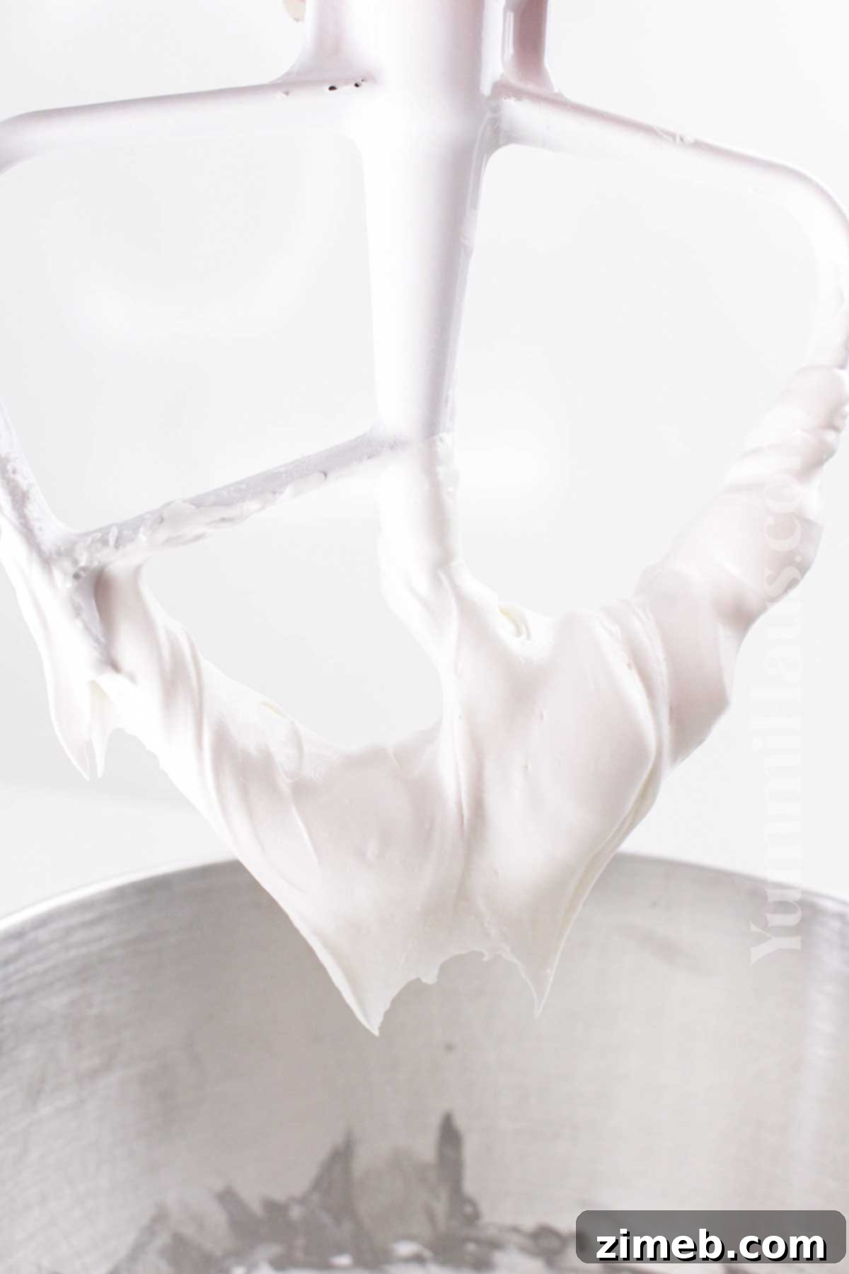 Close-up of freshly made royal icing being mixed to the perfect glossy consistency.