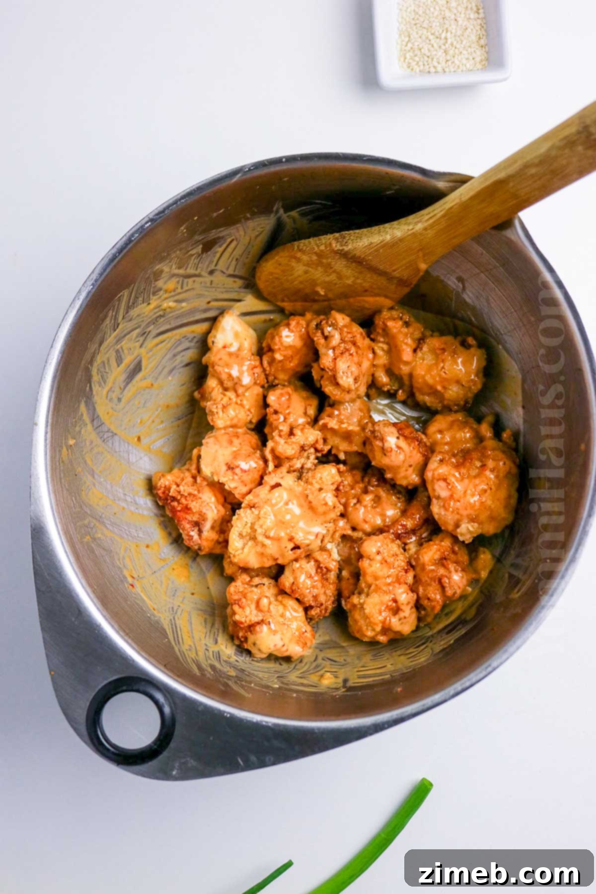 Spicy Bang Bang Chicken 7 tossing to coat in sauce