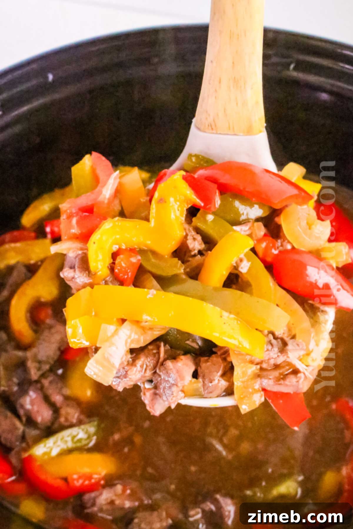 Tender Slow Cooker Pepper Steak 13 A festive dinner spread featuring Slow Cooker Pepper Steak as the centerpiece.