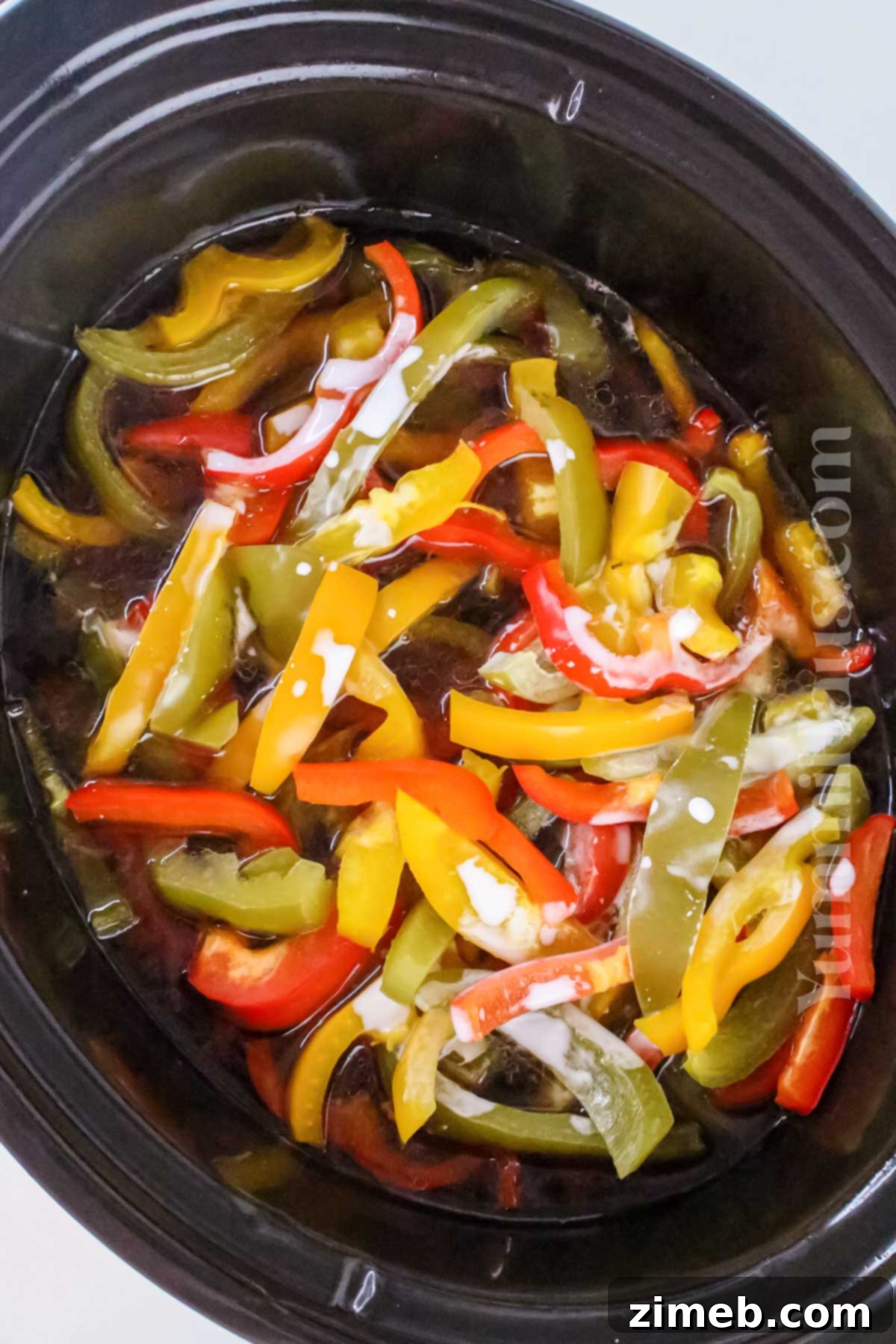 Tender Slow Cooker Pepper Steak 7 Close up of a spoonful of slow cooker pepper steak with rice, ready to eat.