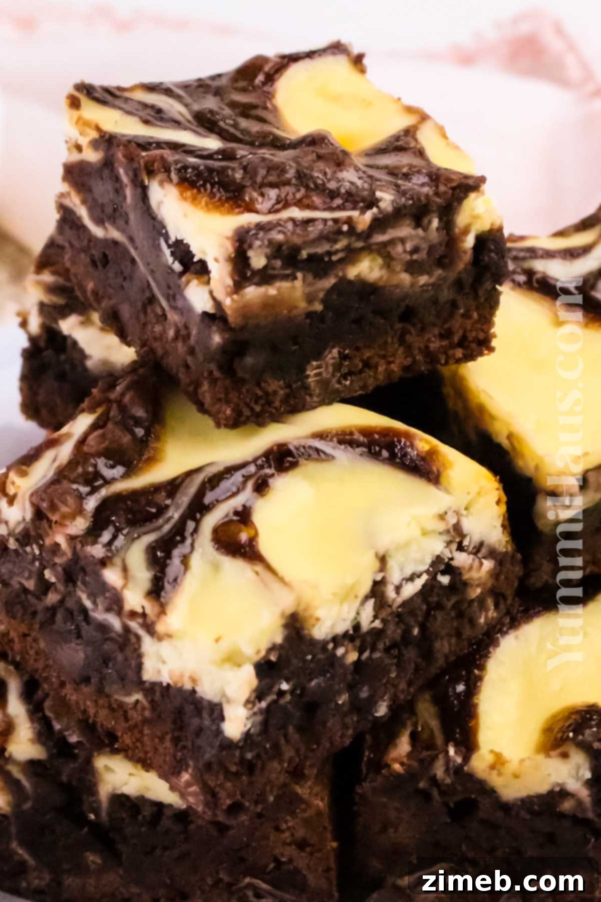 stack of Cheesecake Chocolate Brownies with creamy swirls