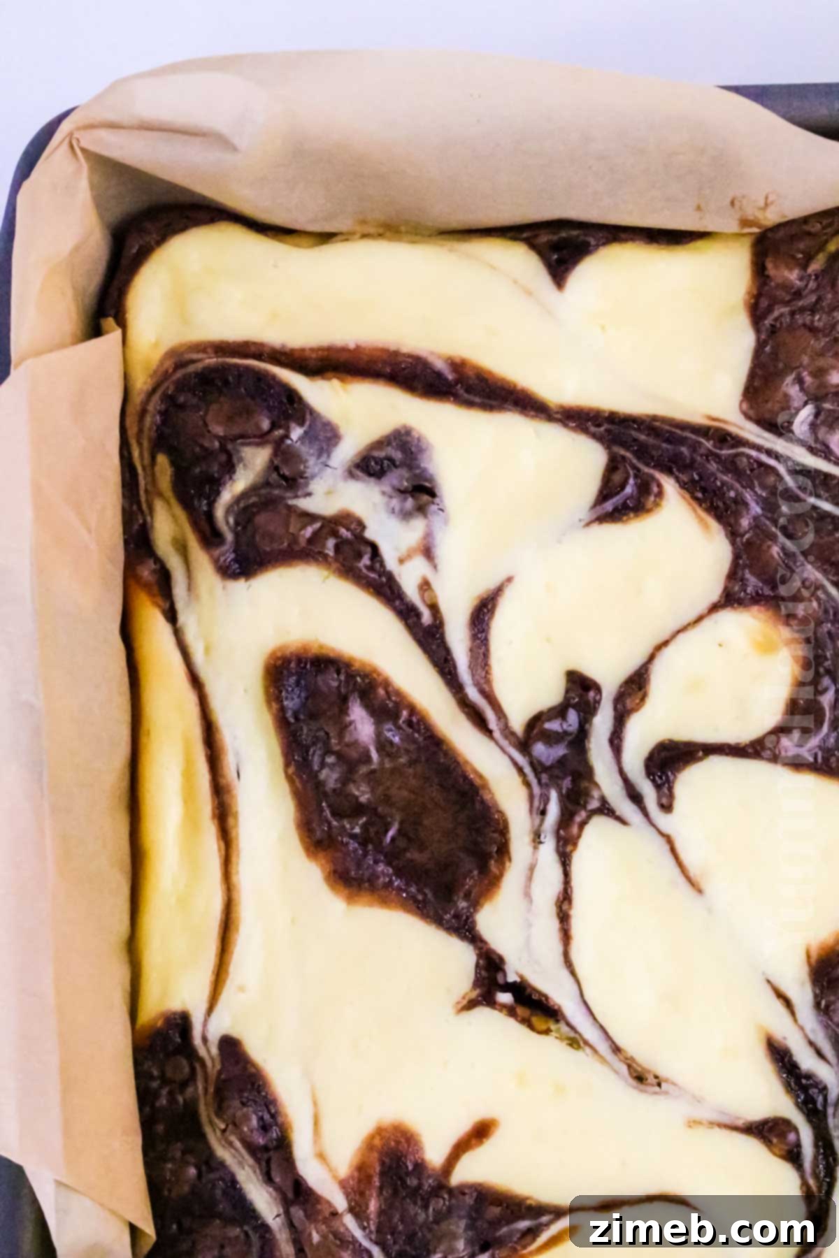 close up of cheesecake swirl on brownie