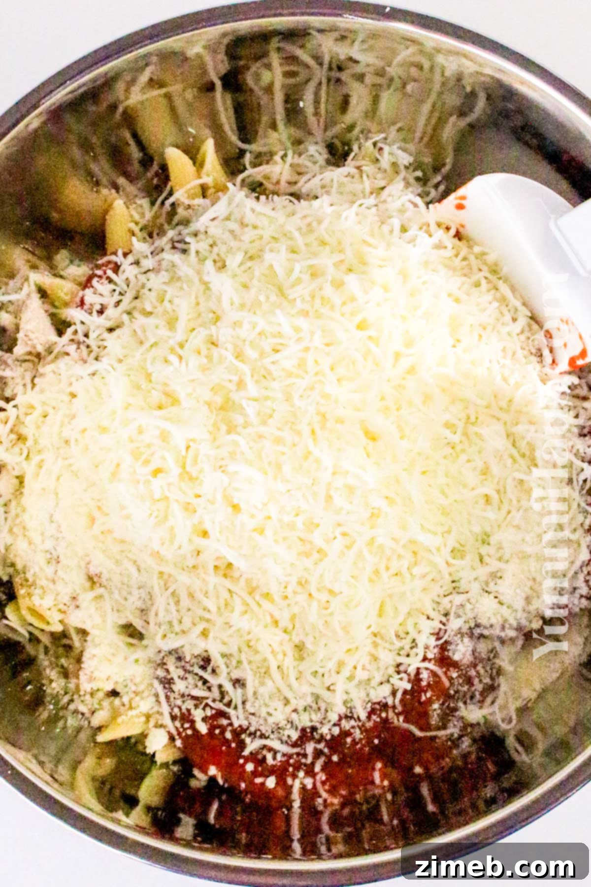 Mixing mozzarella and parmesan cheese for Chicken Parmesan Casserole.
