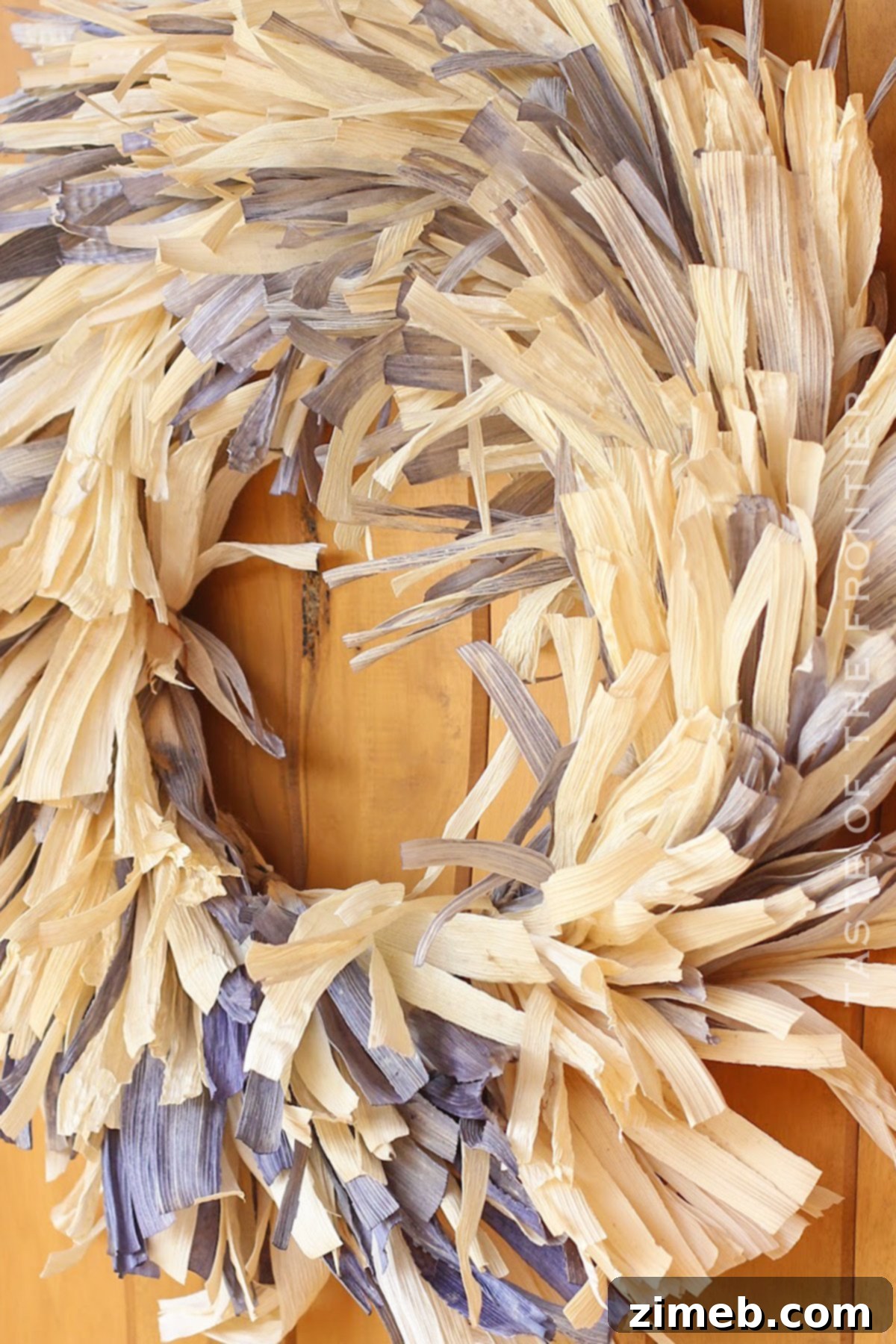 Crafting process of a corn husk wreath, showing husks being prepared
