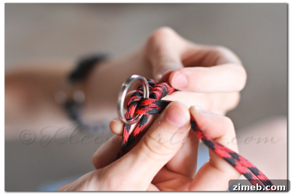 Handmade Fishtail Paracord Dog Collar 14 Sliding a D-ring onto the paracord collar mid-weave