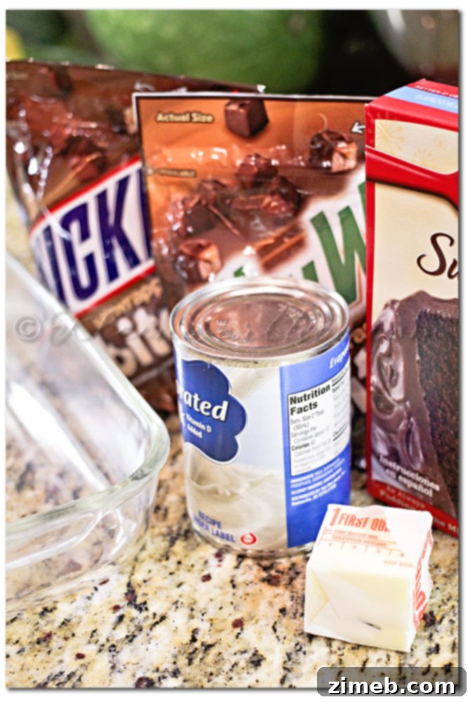 Gathering ingredients for Game Day Bites, including cake mix, butter, evaporated milk, Snickers Bites, and Milky Way Bites.