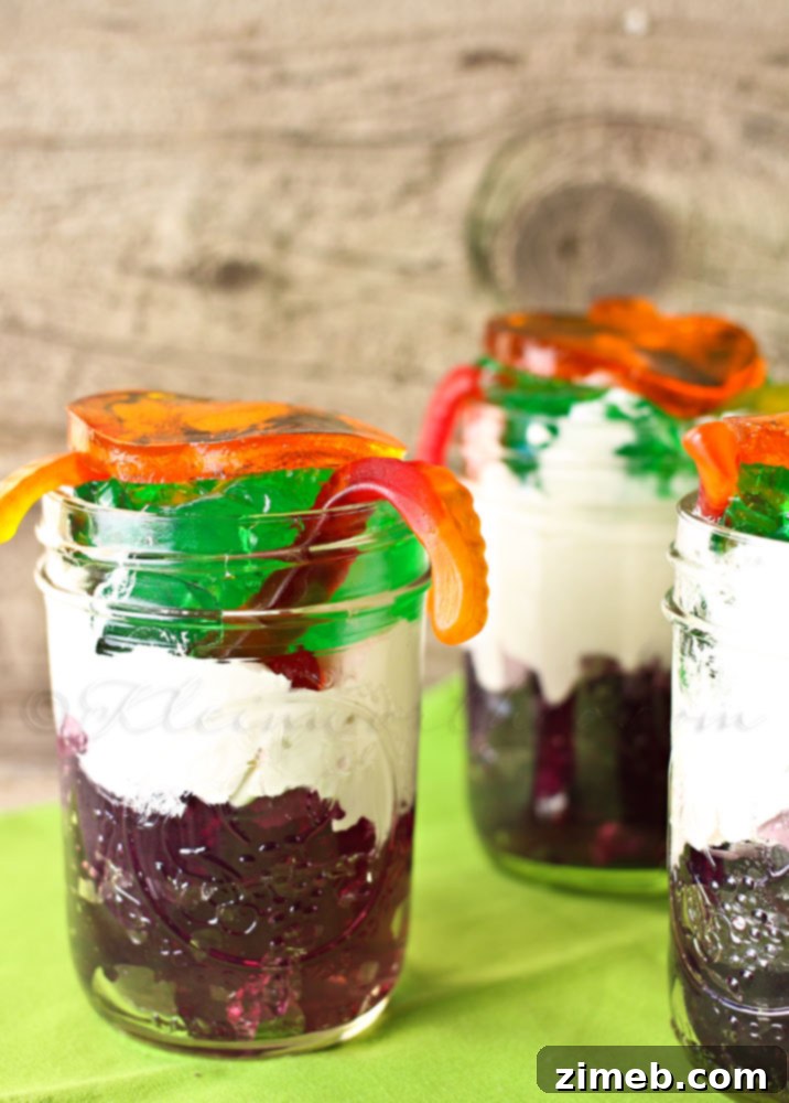 Halloween Jell-O Pumpkin Jigglers: Spooky Party Bites 5 Layered Jell-O jars with gummy worms