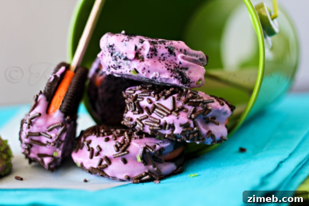 Monster Oreo Pops 3 Two Halloween Oreo Cookies with chocolate and sprinkles on a wooden board